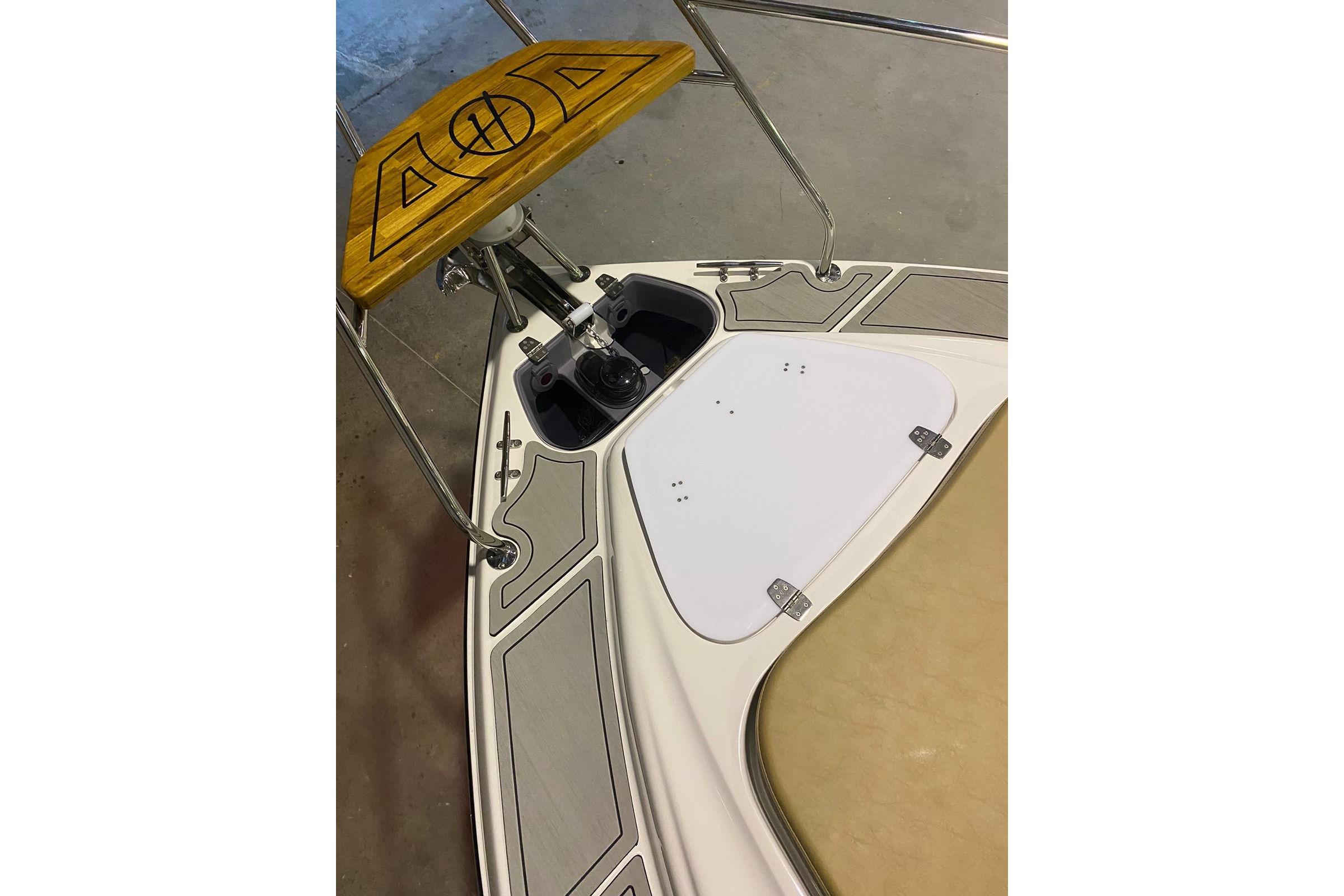 2024 Hanover 305 boat deck with wooden accents and stainless steel fittings.