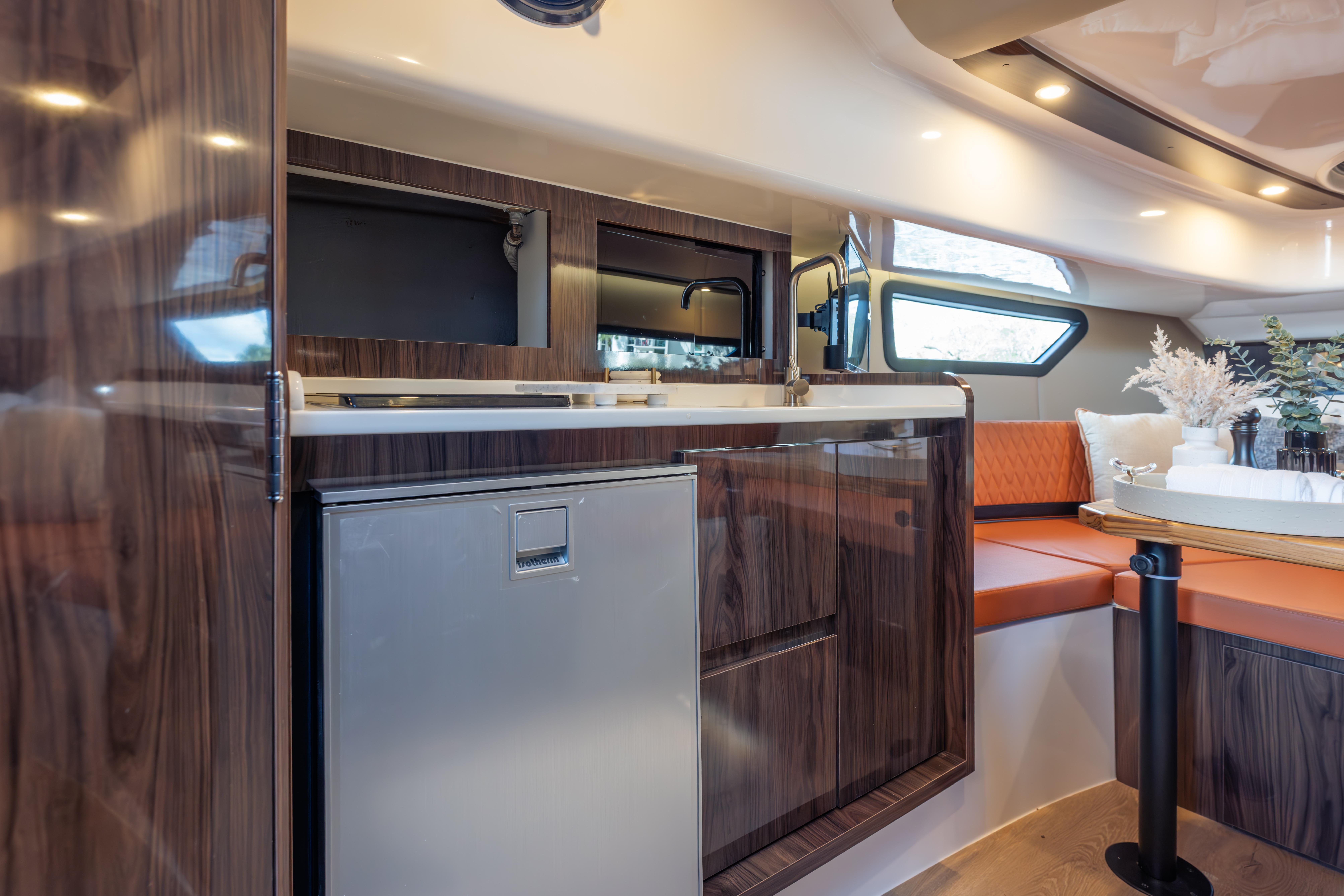 Luxurious Hanover 387 yacht interior with modern kitchen and cozy seating, 2026 model.