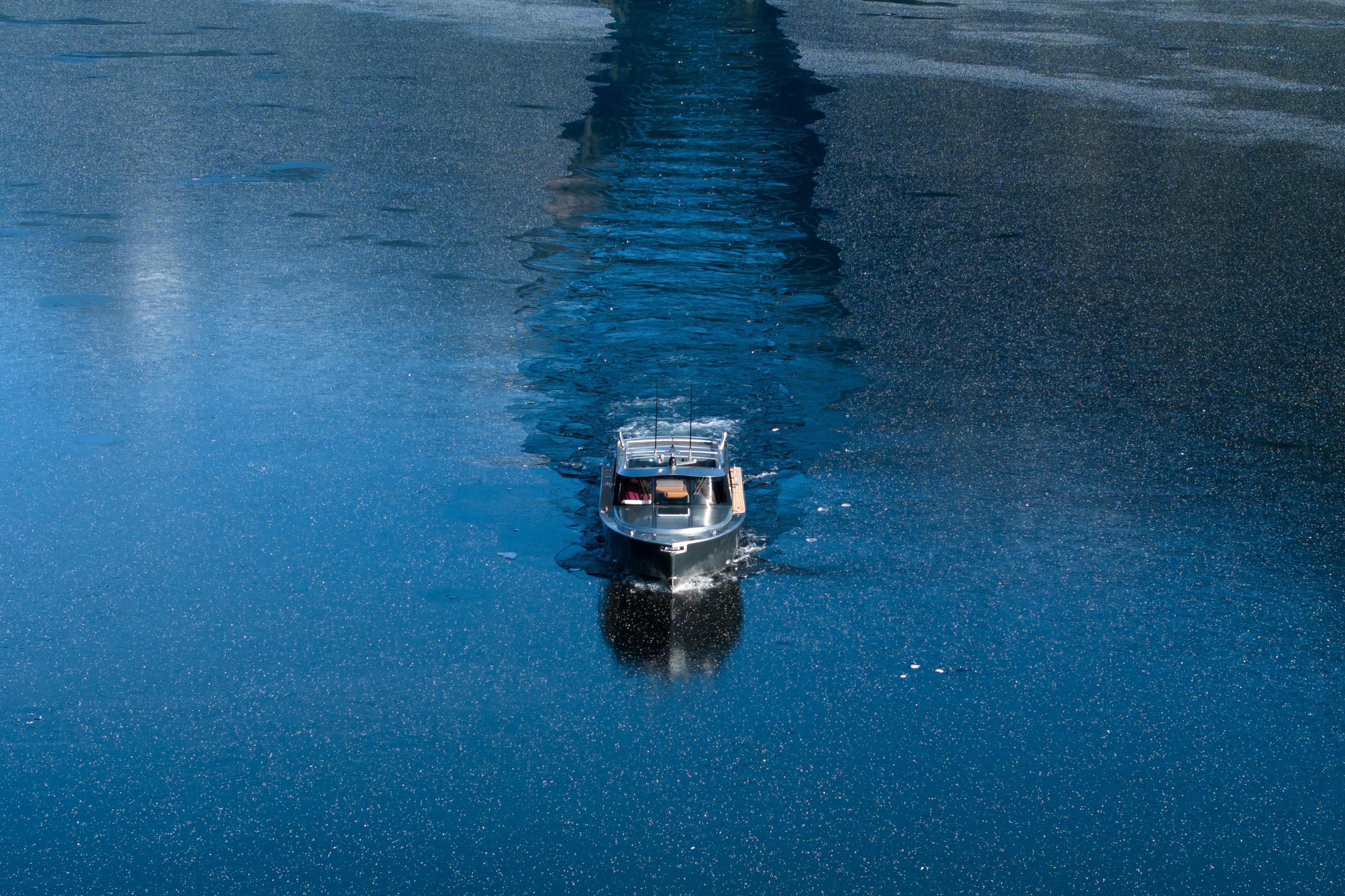 Boat cruising on calm water, Jasper Marine Defender 22, 2026 model.