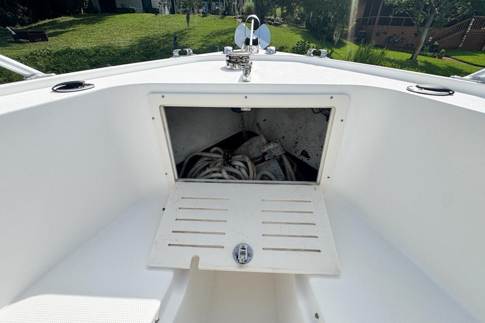 Open storage compartment on a 2018 Mako 284 Center Console boat, showing ropes and anchor.