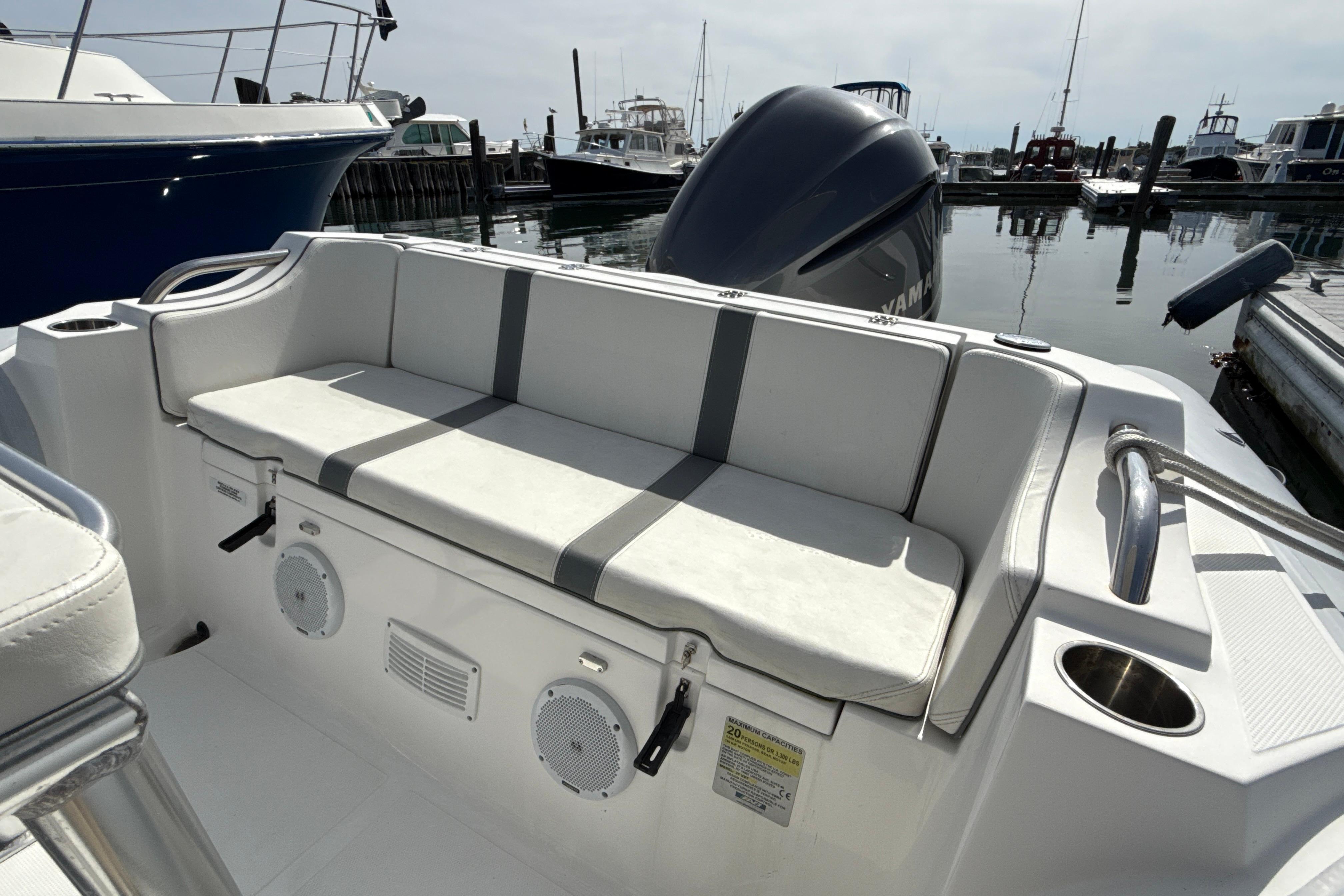 2020 AB Inflatables Oceanus 21 VST boat with cushioned seating and speakers at a marina.