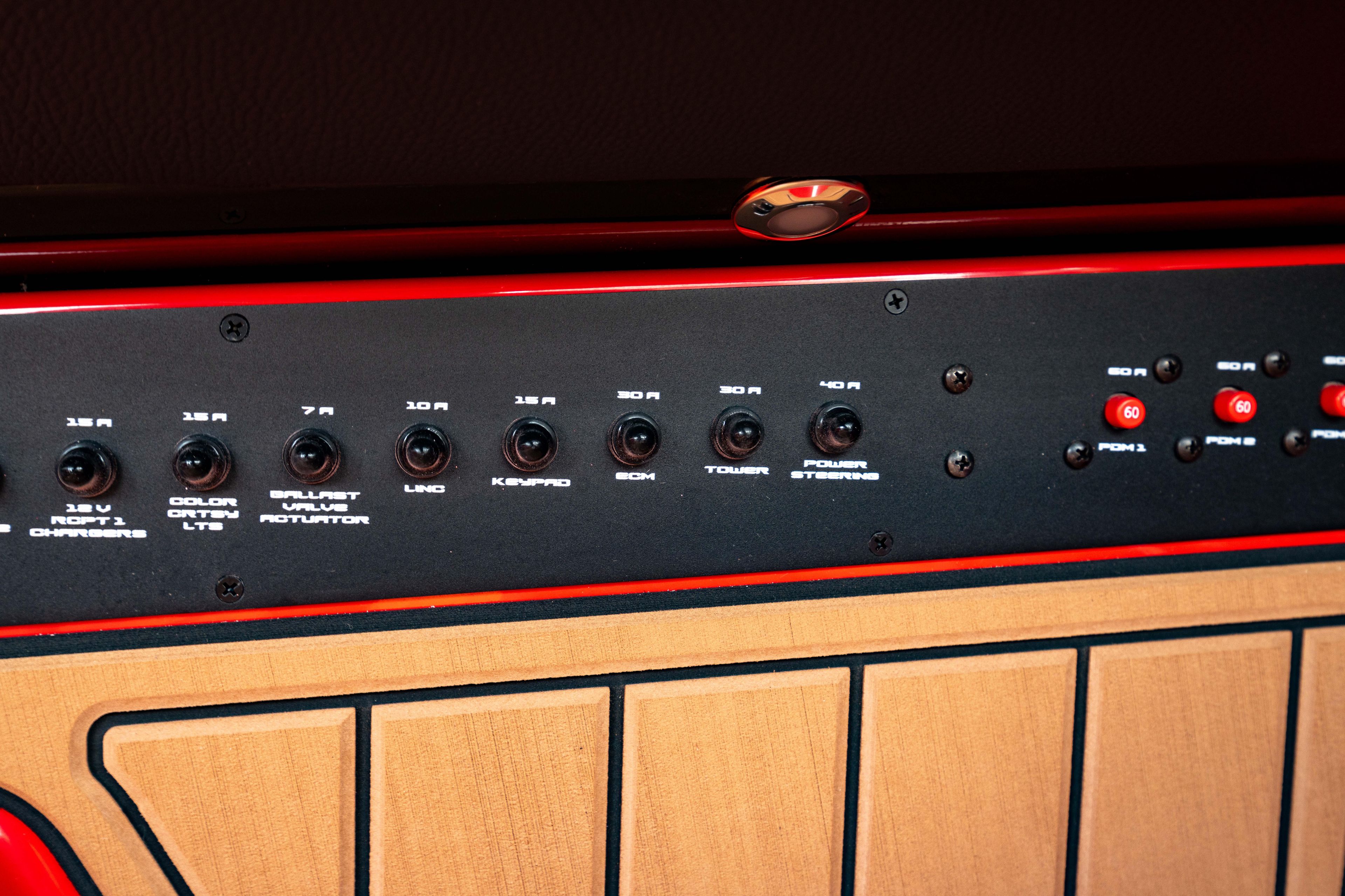 Control panel of 2025 Nautique Super Air Nautique GS20 boat, featuring various switches and dials.