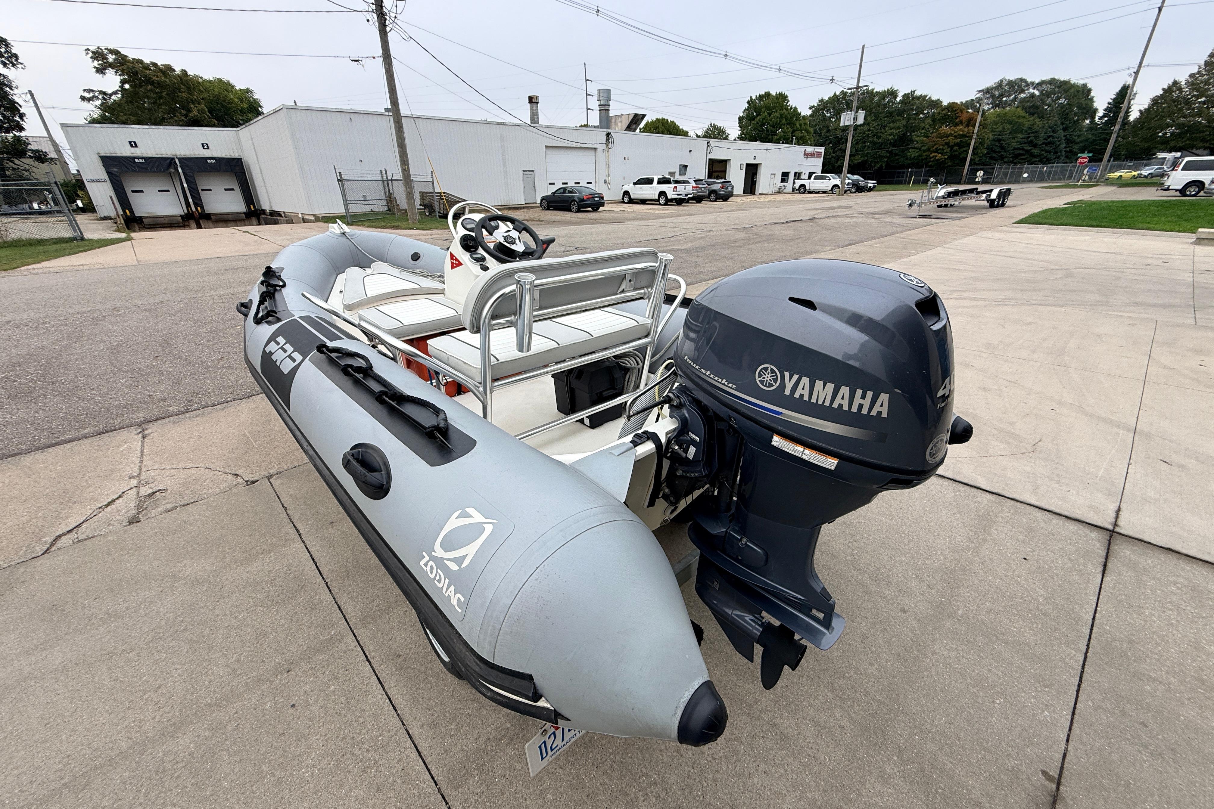 2014 Zodiac Pro Classic 420 inflatable boat with Yamaha outboard motor, parked outdoors.