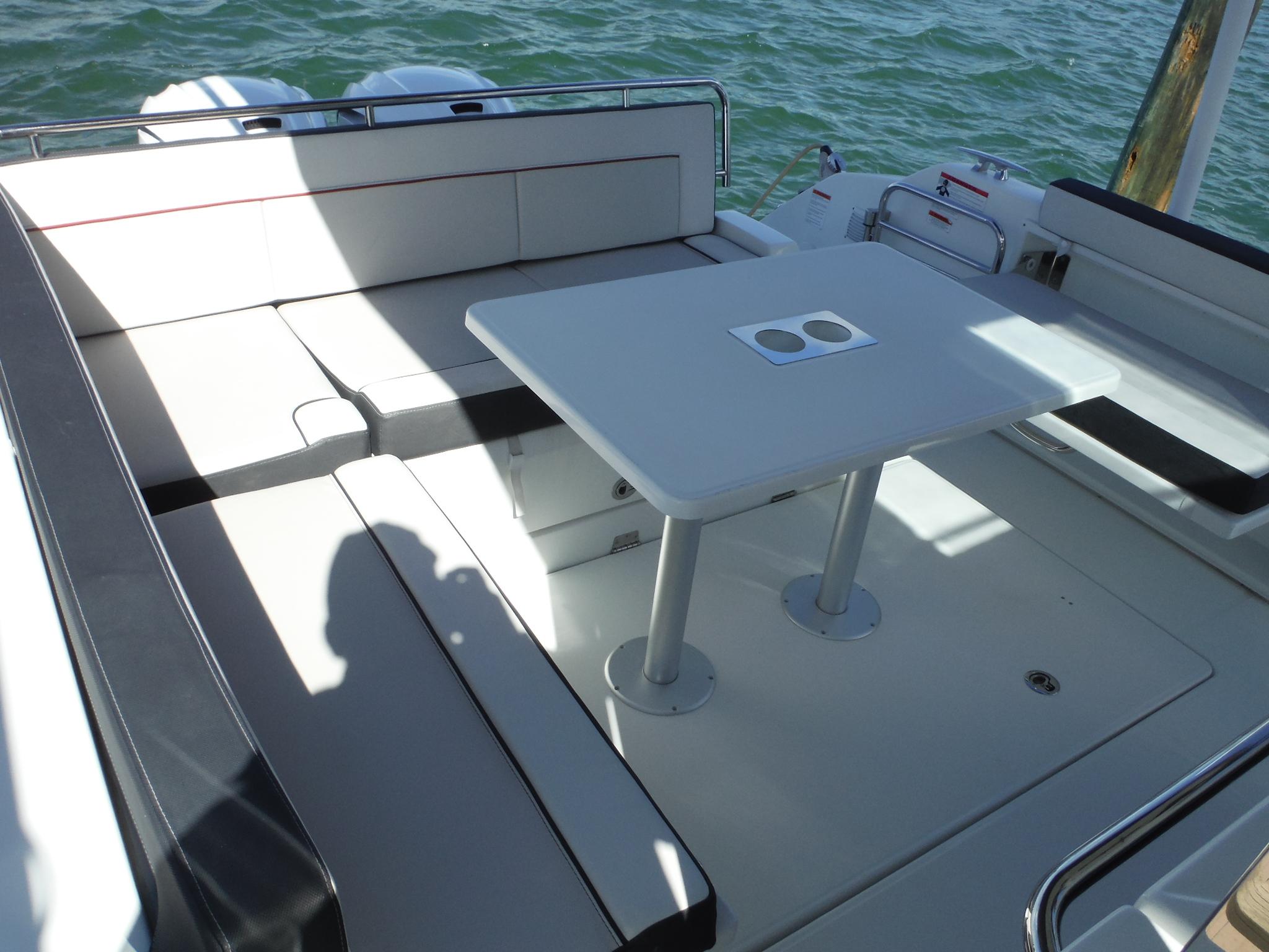 2023 Jeanneau Leader 10.5 WA Series 2 boat interior with seating and table.