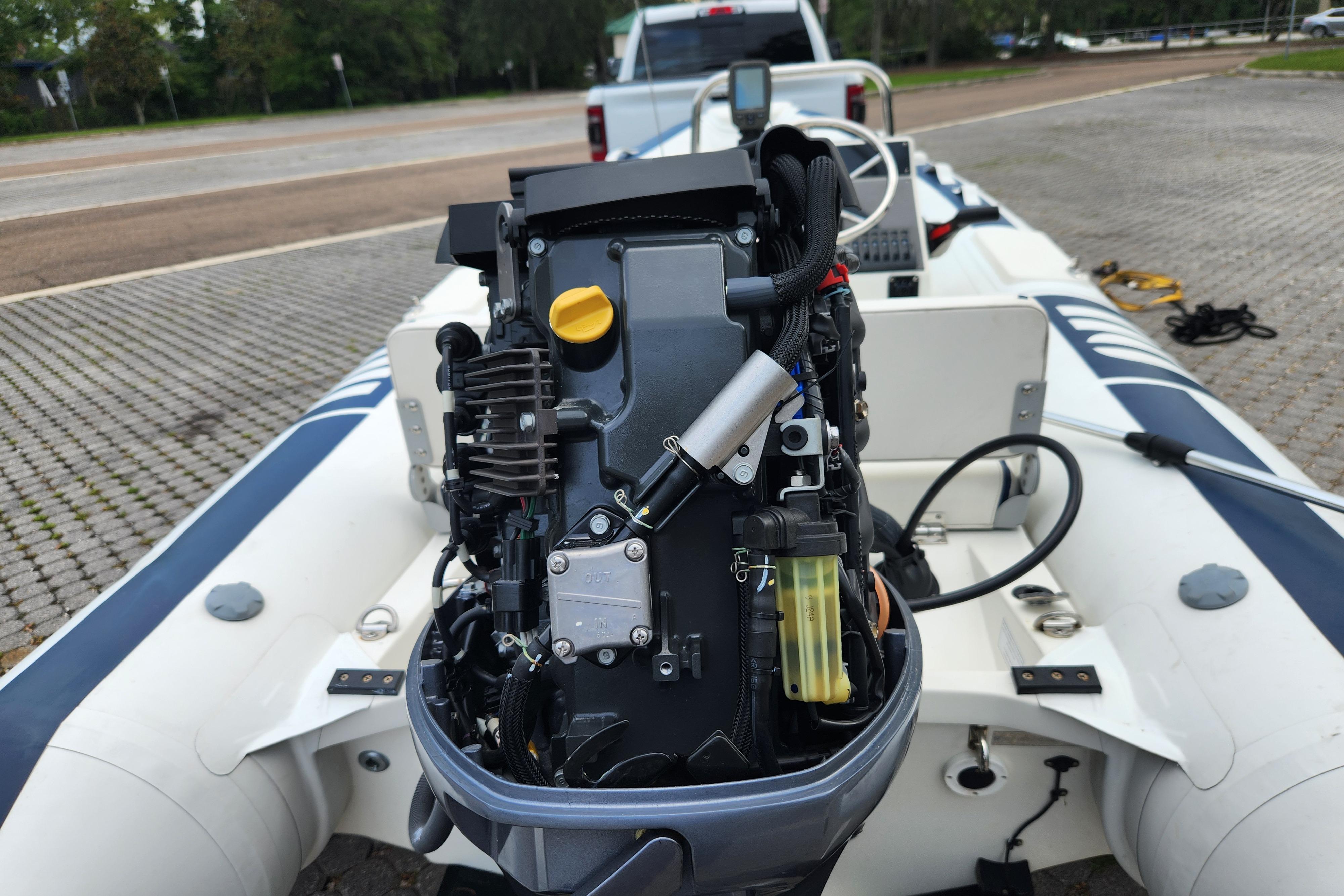 2019 Novurania DL 400 boat with exposed engine, parked on a paved area.