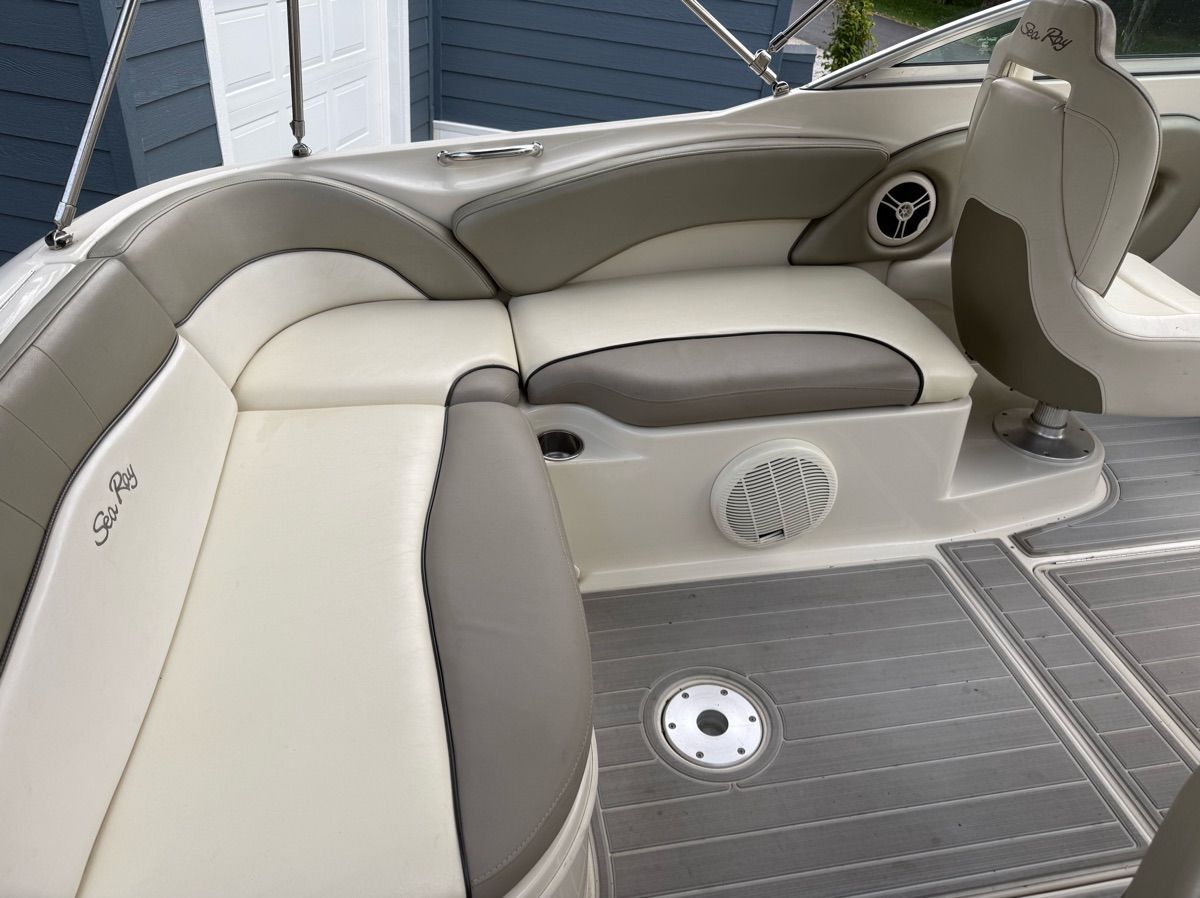 The image shows the cockpit of a 2007 Sea Ray 240 Sundeck with gray and white seating.