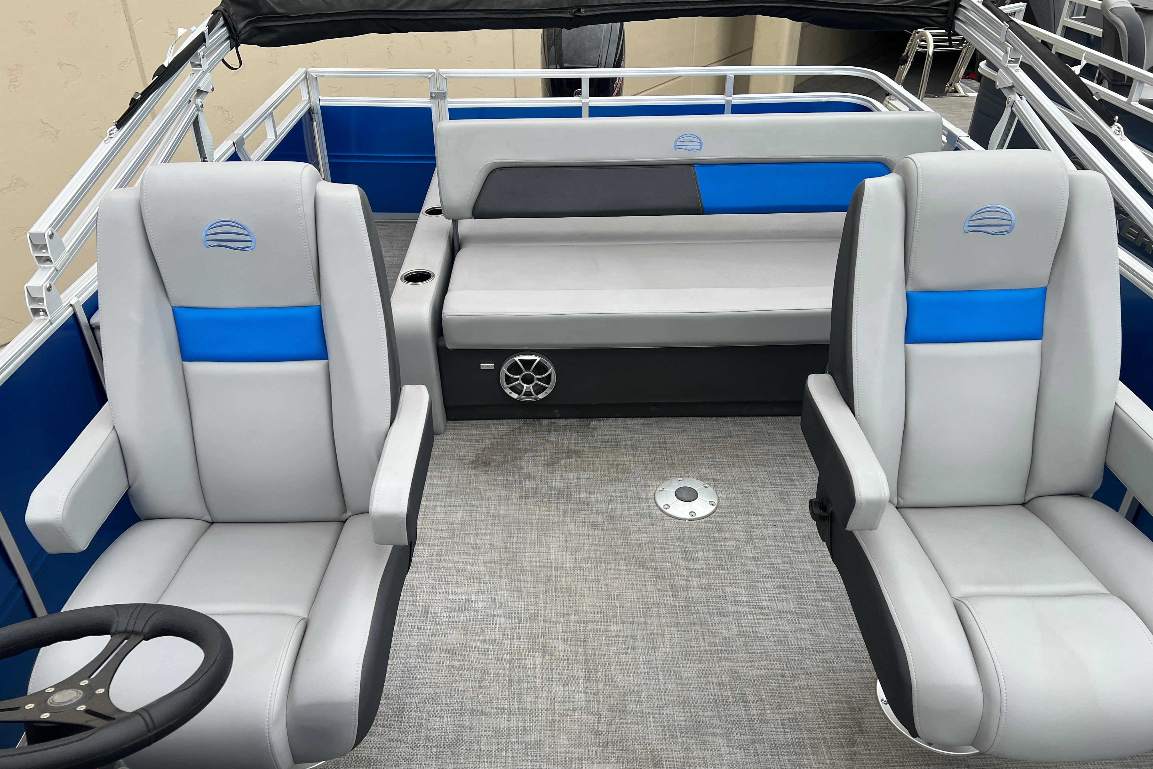 2026 Sun Tracker Party Barge 22 RF DLX interior with gray and blue seating.