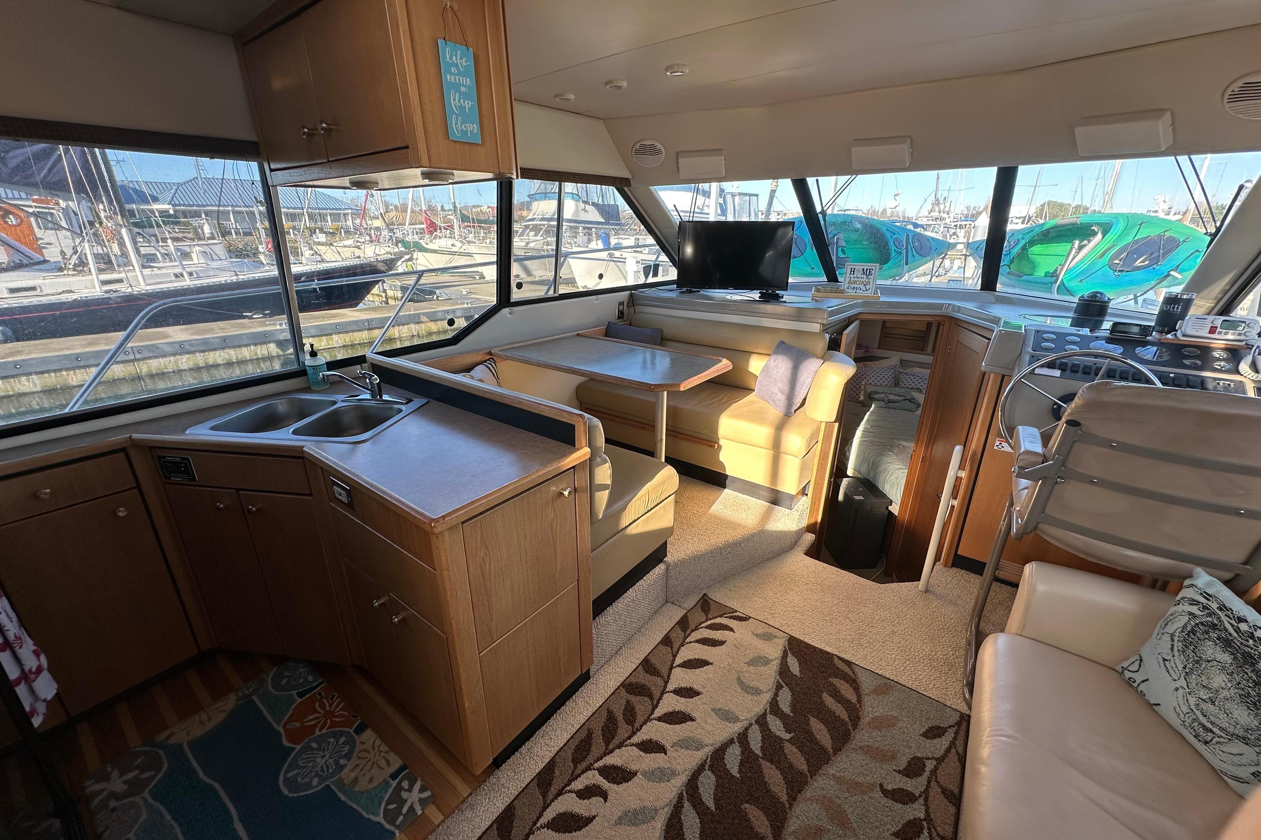 Interior of 2000 Bayliner 4087 Aft Cabin Motoryacht with kitchen, seating, and helm.