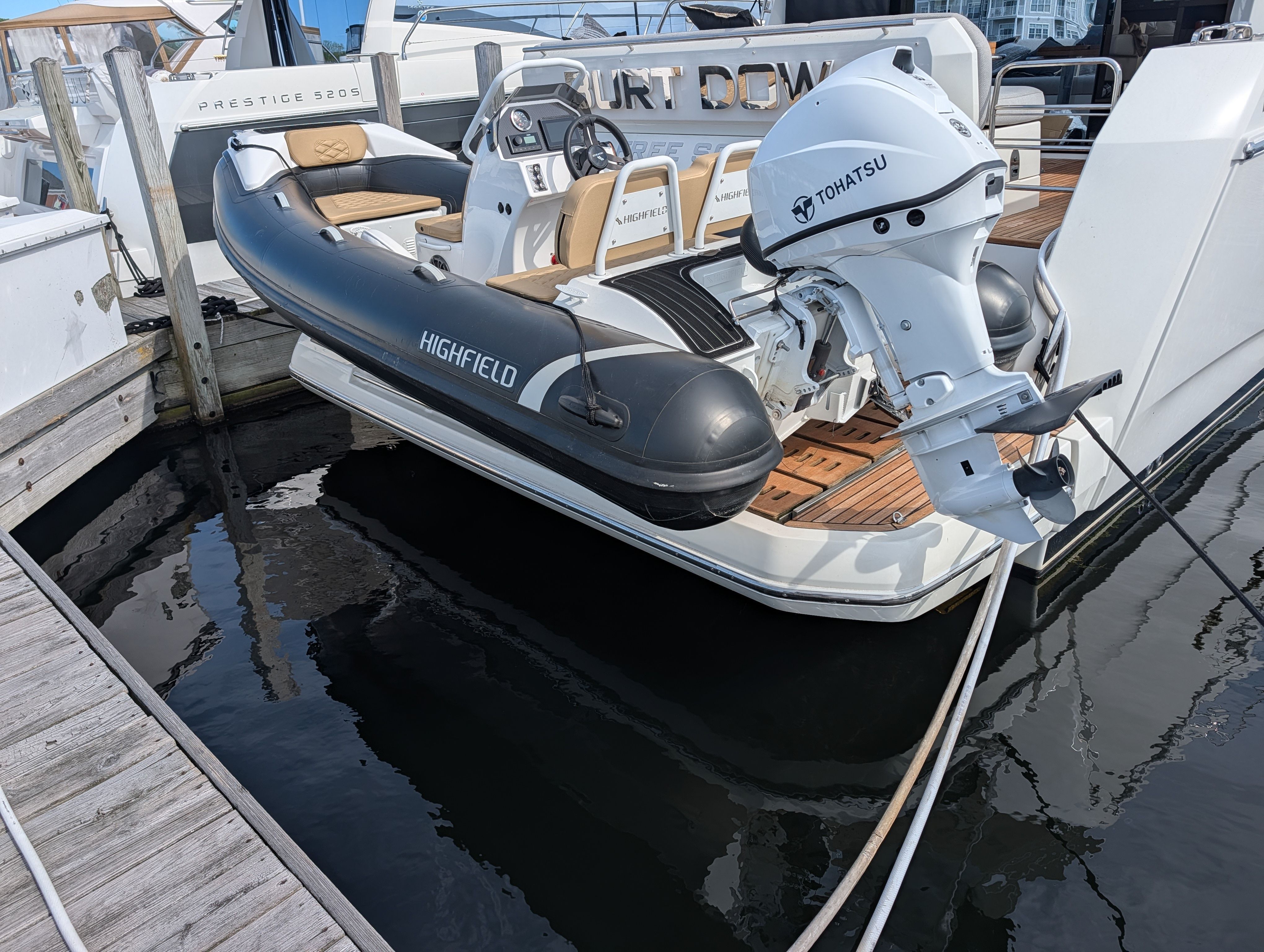 2024 Highfield Sport 390 inflatable boat with Tohatsu engine docked.