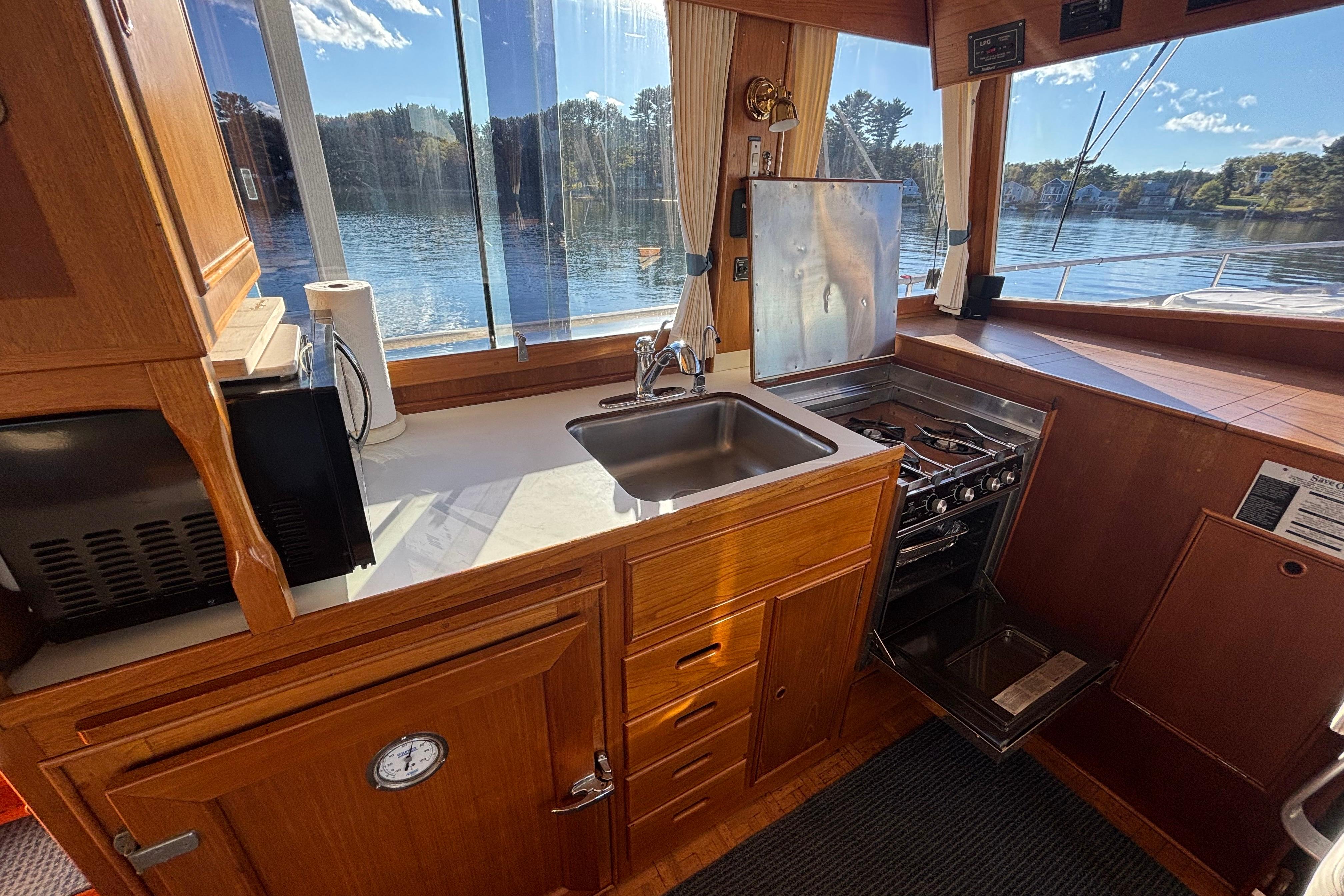 Interior of 1989 Grand Banks 46 Classic yacht with kitchen and scenic water view.