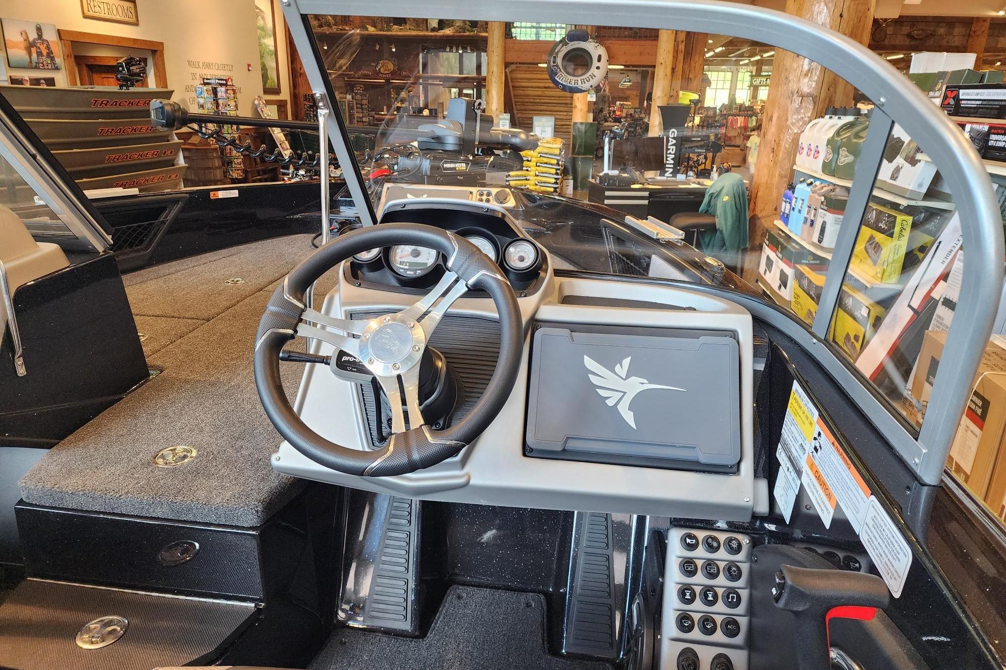 Interior view of 2025 Ranger 1880MS boat dashboard in a showroom setting.