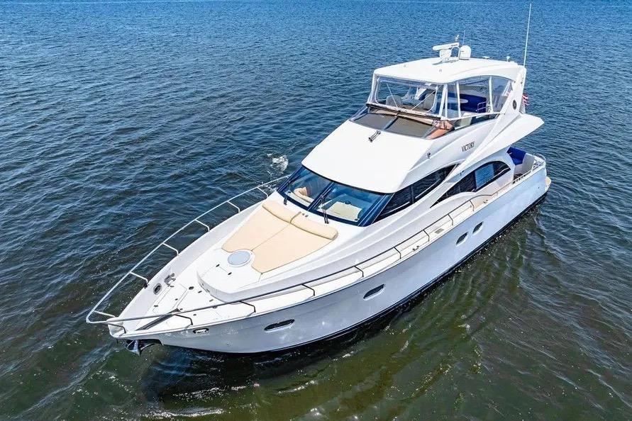 Luxurious 2005 Marquis 59 yacht cruising on open water.