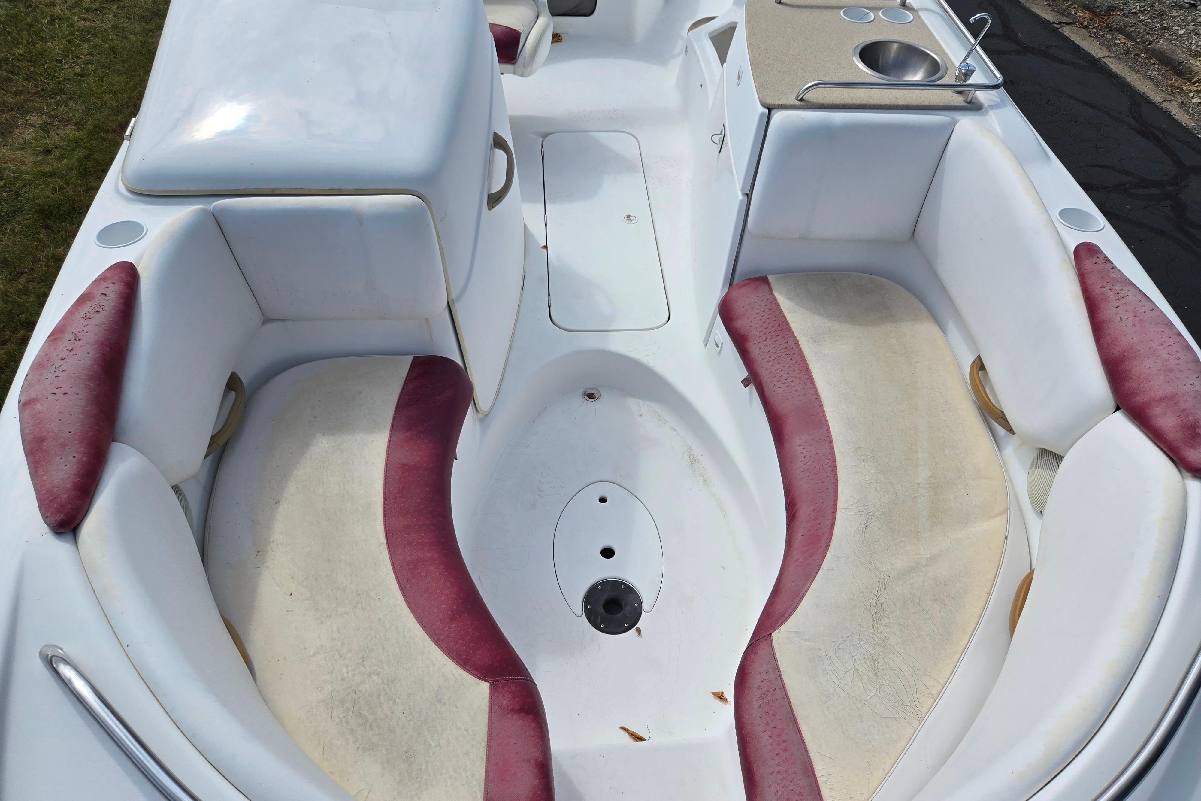 2004 Sea-Doo Islandia boat interior with red and white seating, sink, and storage.
