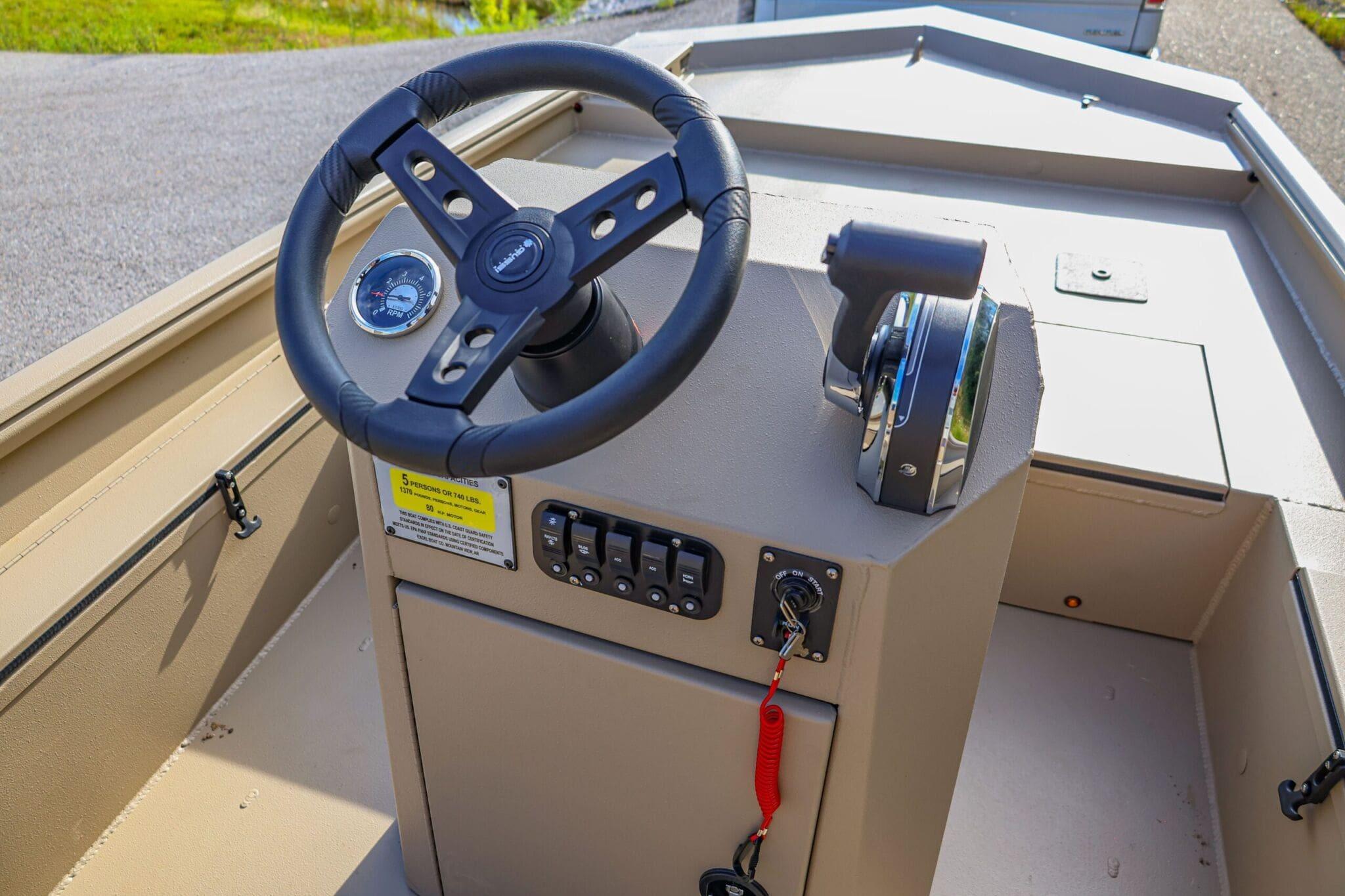 2026 Excel Switchblade boat dashboard with steering wheel and control panel.