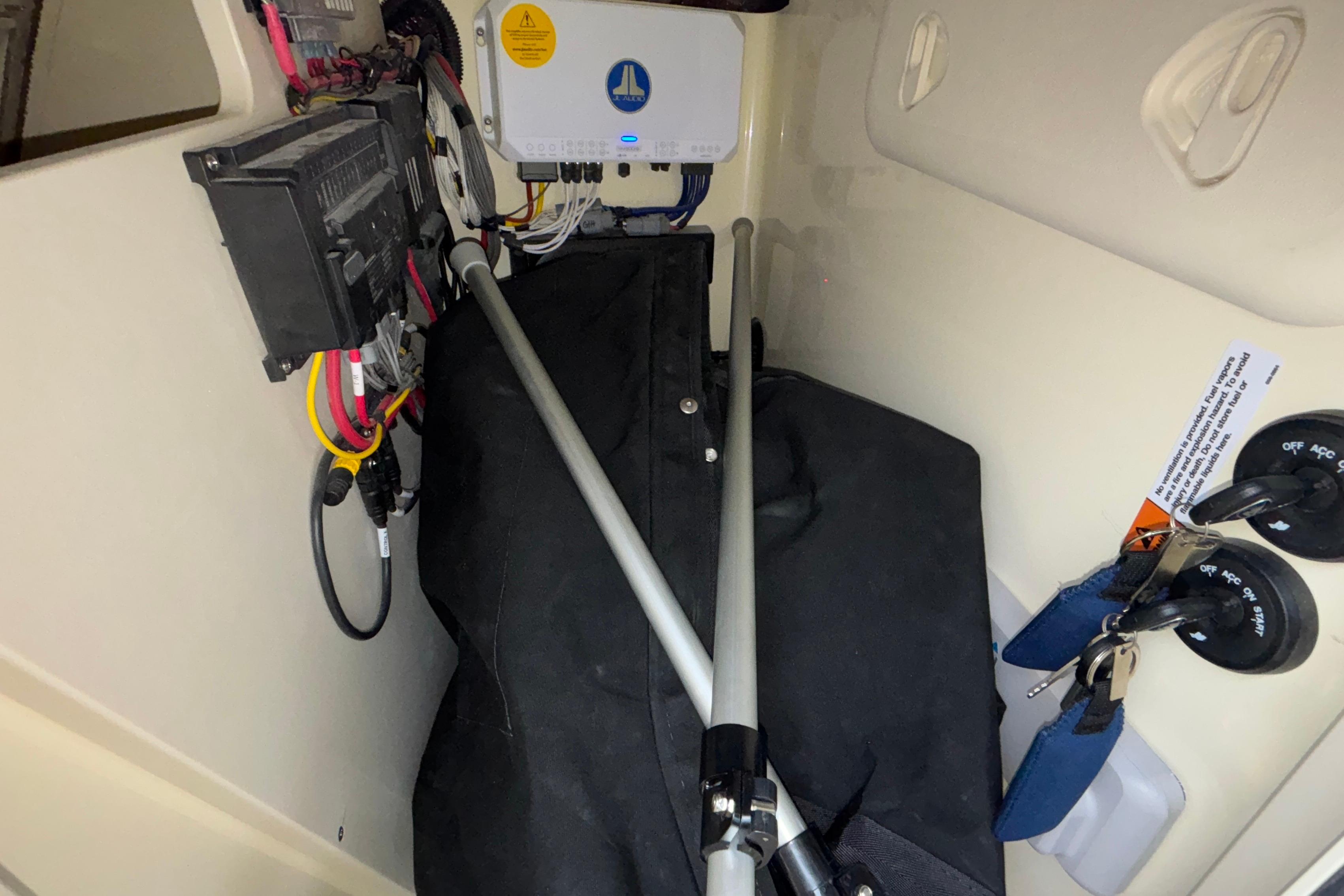 Interior view of 2026 Chris-Craft Calypso 28 boat showing electrical components and storage.