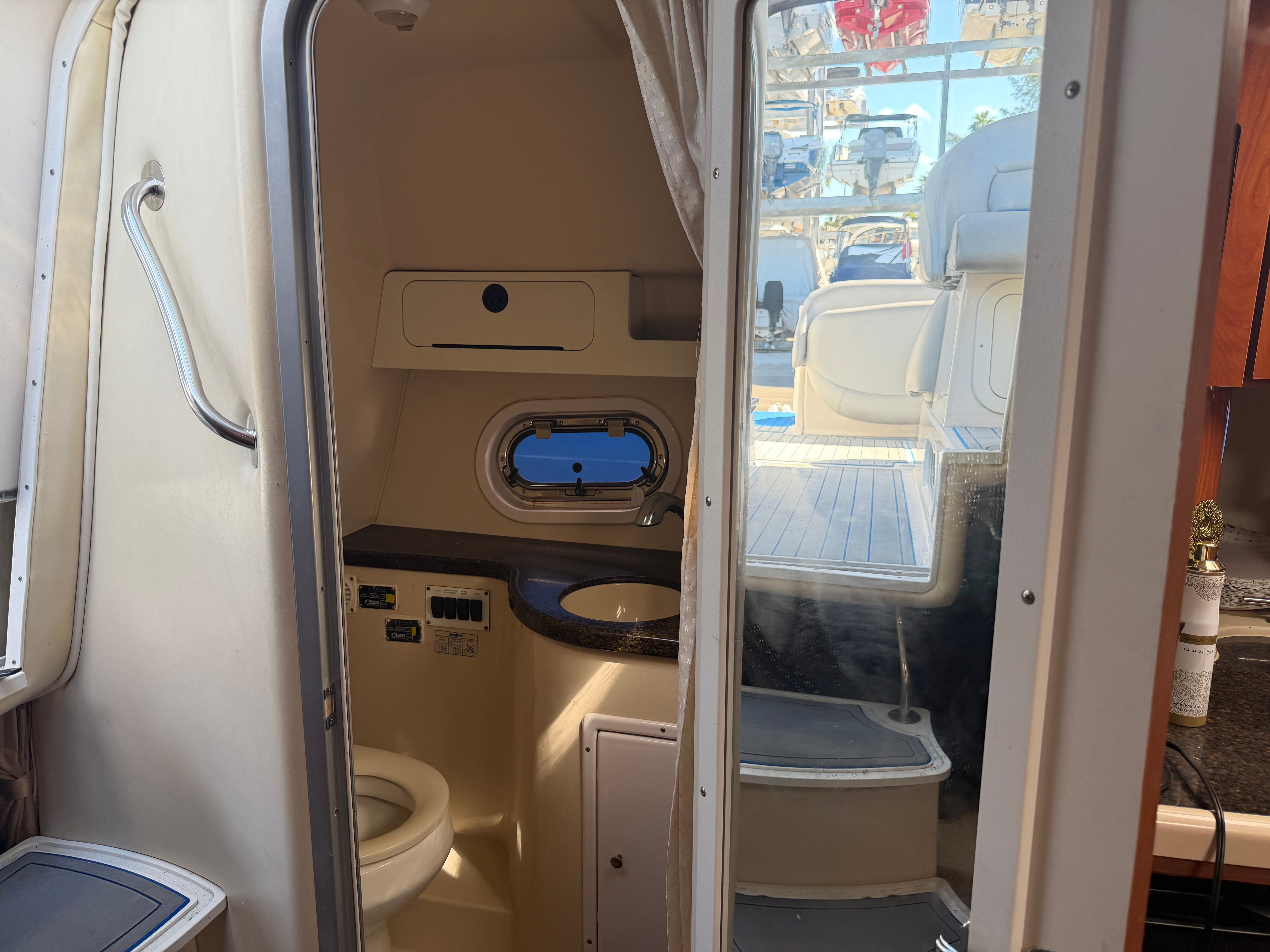 Interior of a 2006 Four Winns 328 Vista yacht with bathroom and deck view.