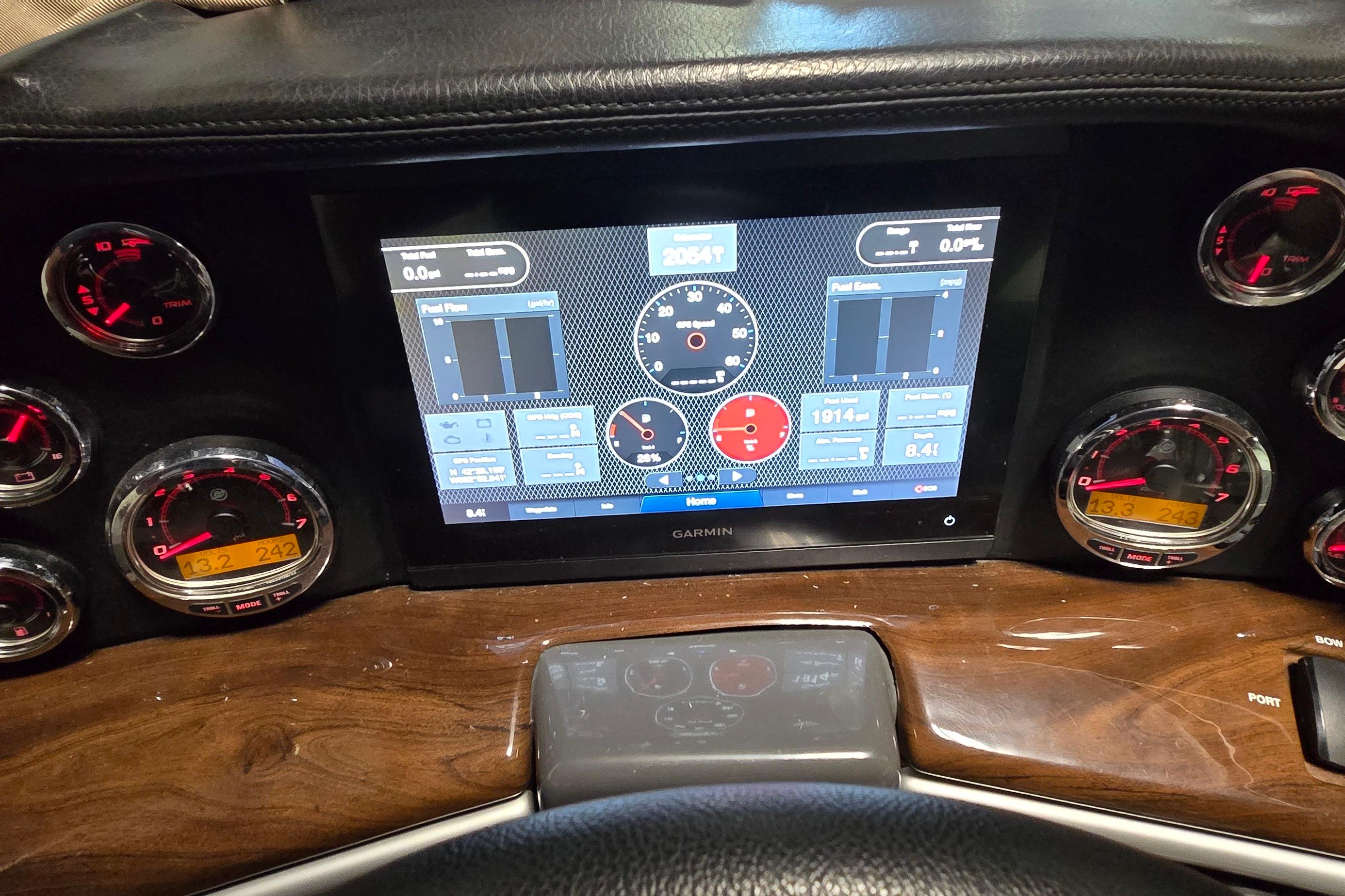 Dashboard of a 2018 Four Winns V355 boat with Garmin display and gauges.