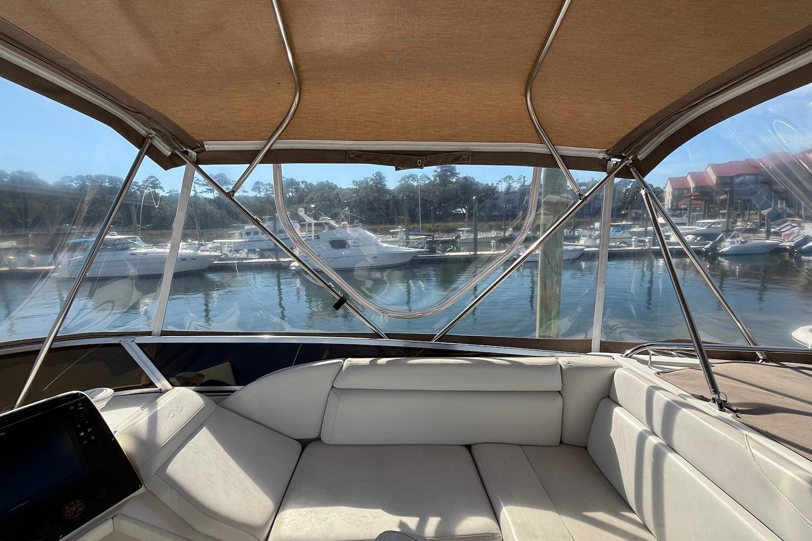 Interior view of 2003 Regal Commodore 3880 yacht at marina, featuring comfortable seating.