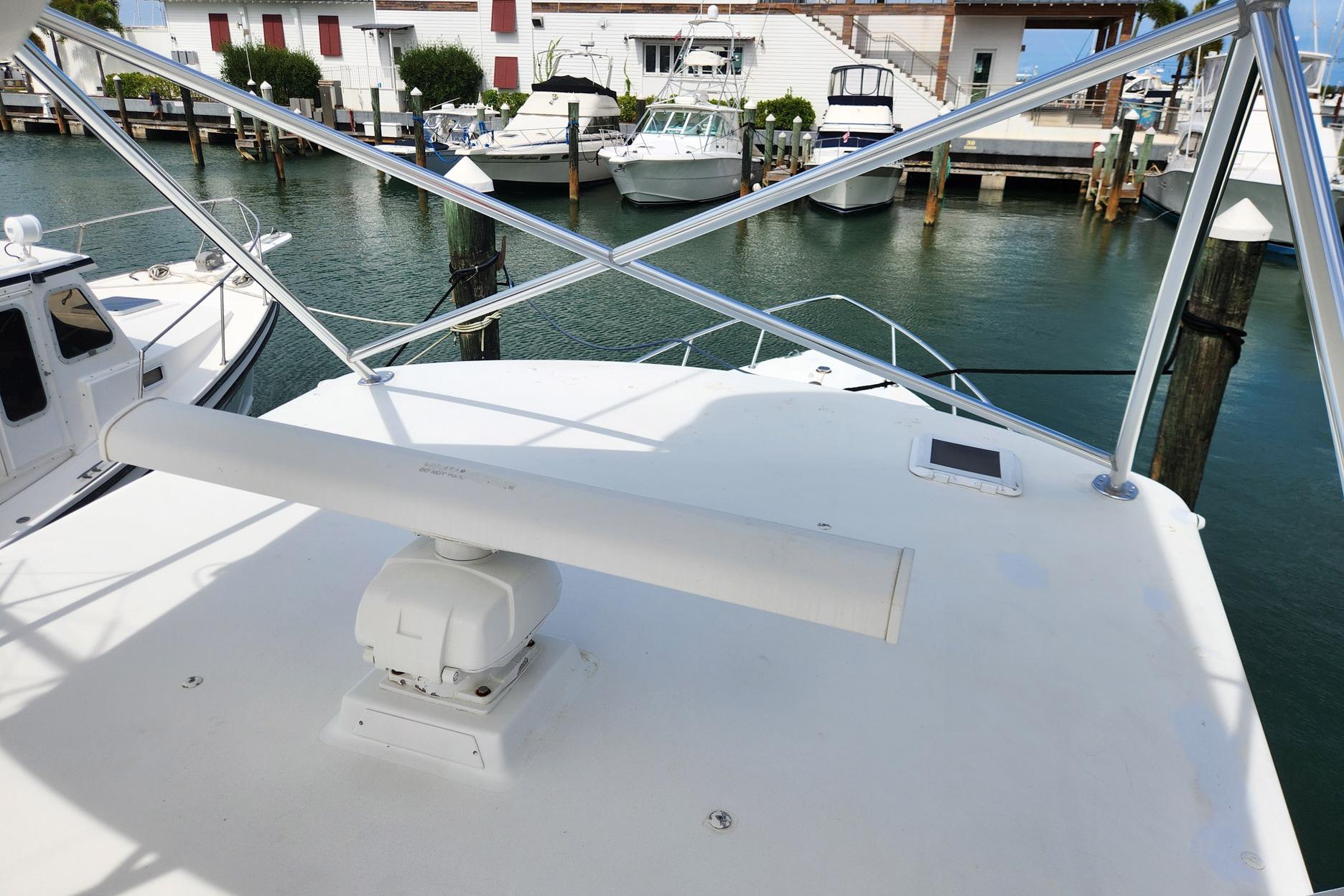 1987 Young Brothers Custom Sport Fish boat docked at marina, featuring radar equipment.