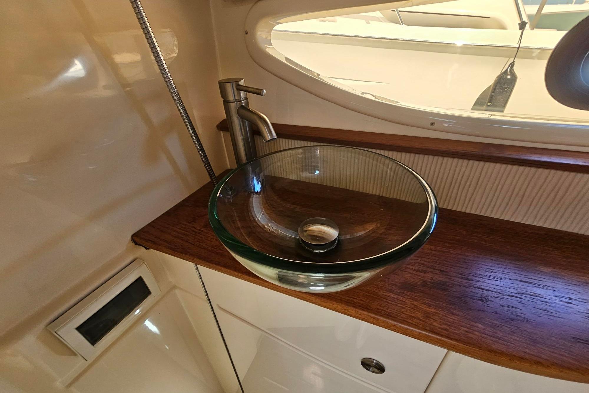 2016 Sea Ray Sundancer 350 bathroom with glass vessel sink and modern faucet.