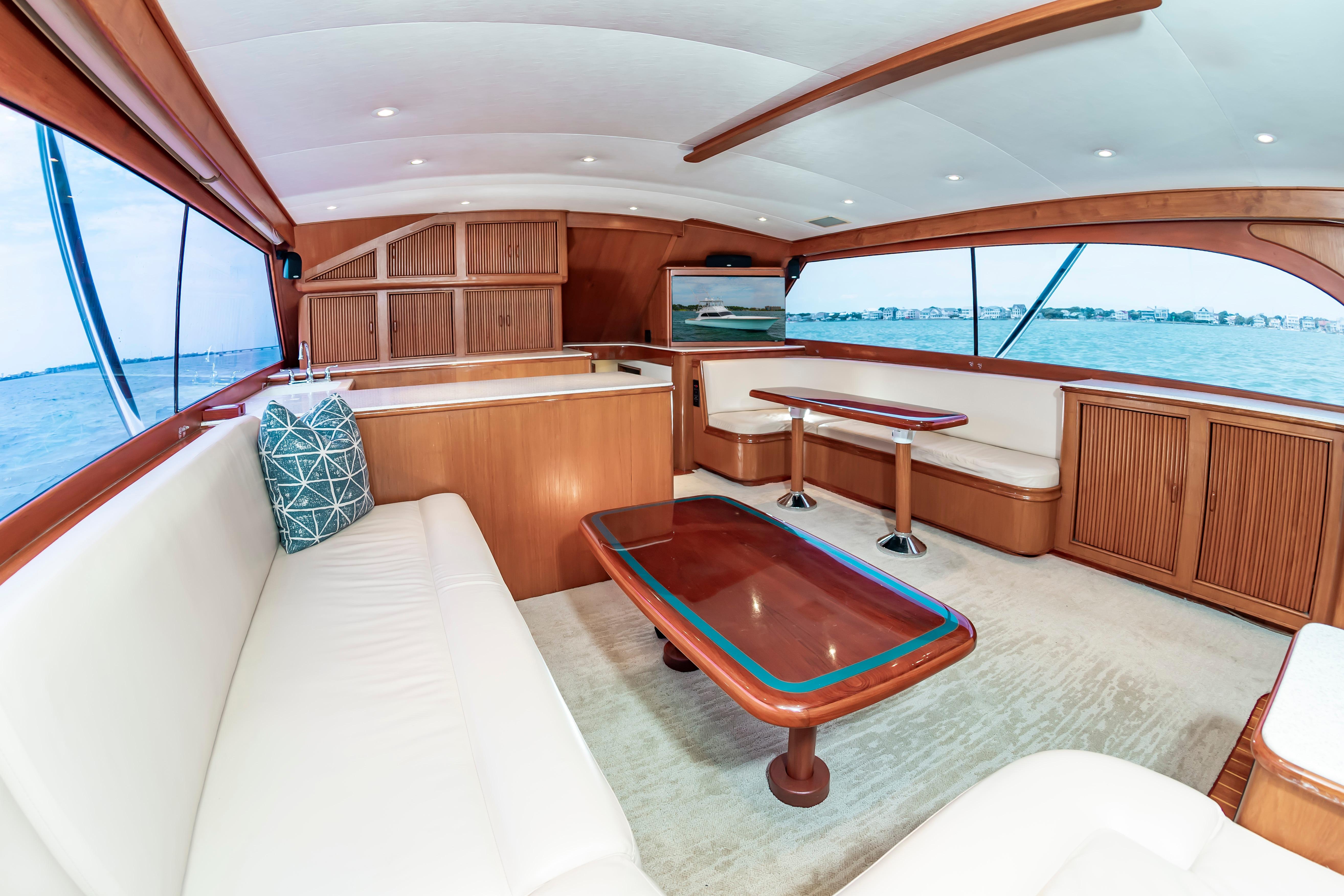 Luxurious interior of 1993 Custom Carolina Scarborough 56 Convertible yacht with elegant wood finishes.