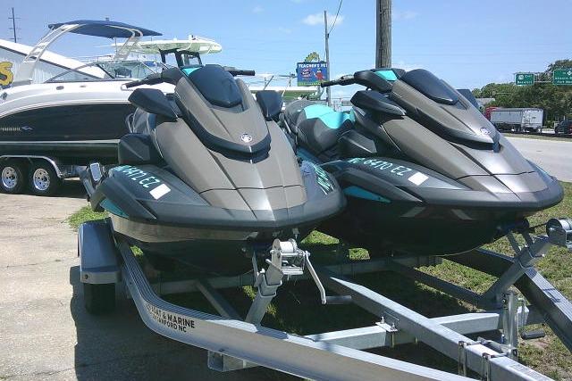 2023 Yamaha FX Cruiser HO jet skis on a trailer, parked outdoors.