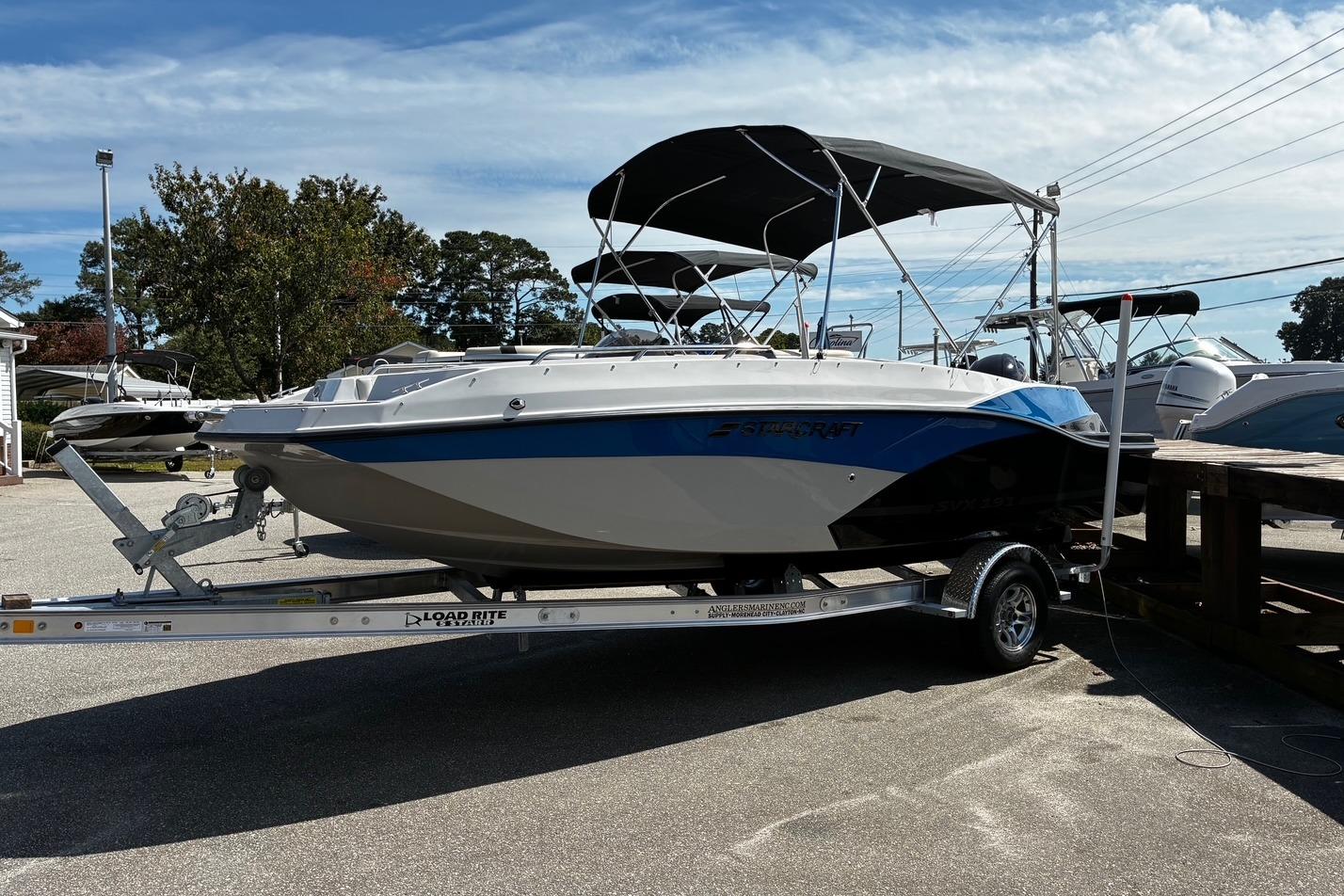 2026 Starcraft SVX 191 OB boat on trailer, parked outdoors under a clear sky.