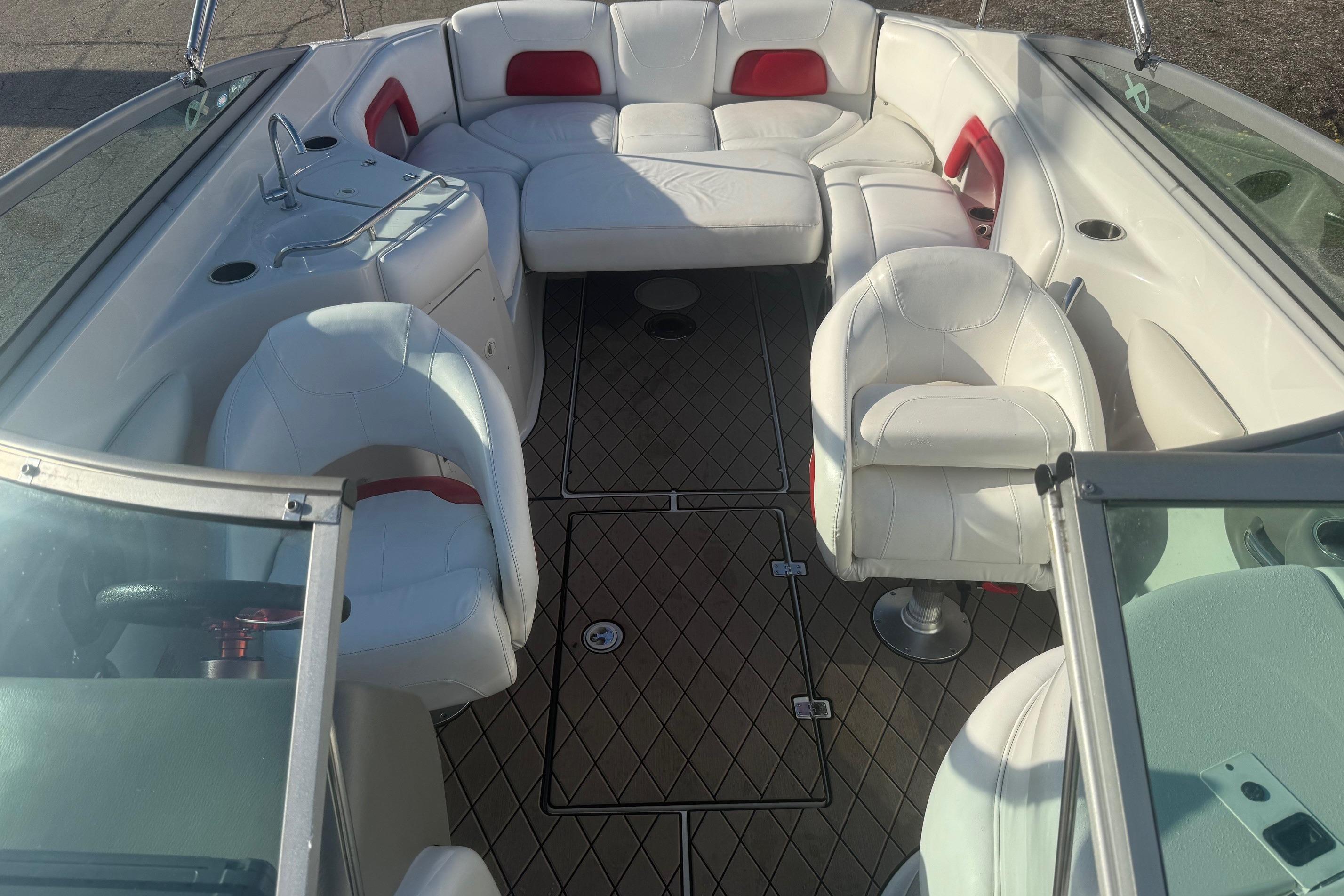 2005 Crownline 270 BR boat interior with white seating and red accents.