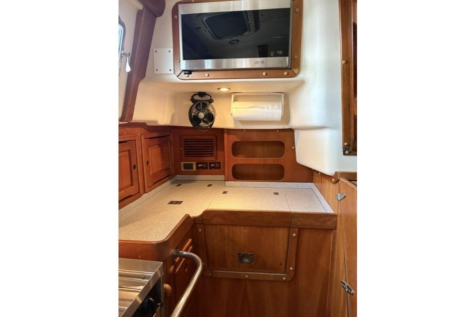 Interior of 2002 Saga 43 yacht with wooden cabinetry and modern amenities.