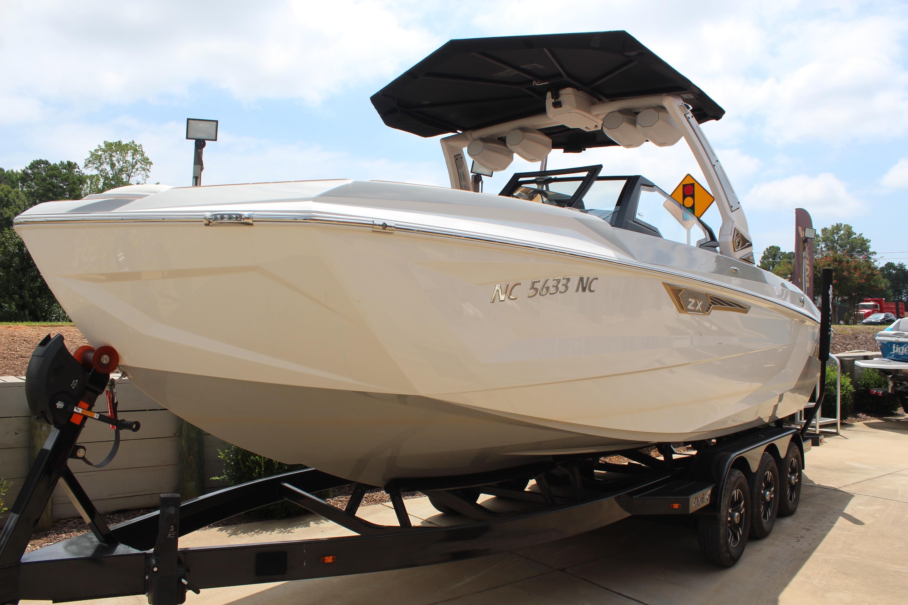 2024 Tigé Ultré 25ZX boat on trailer, sleek design, outdoor display.