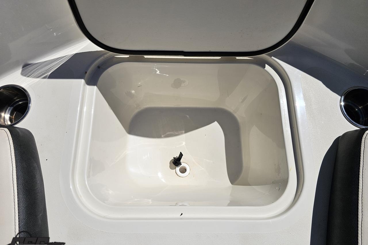 2023 Stingray 182 SC boat storage compartment with open lid, showcasing interior space.