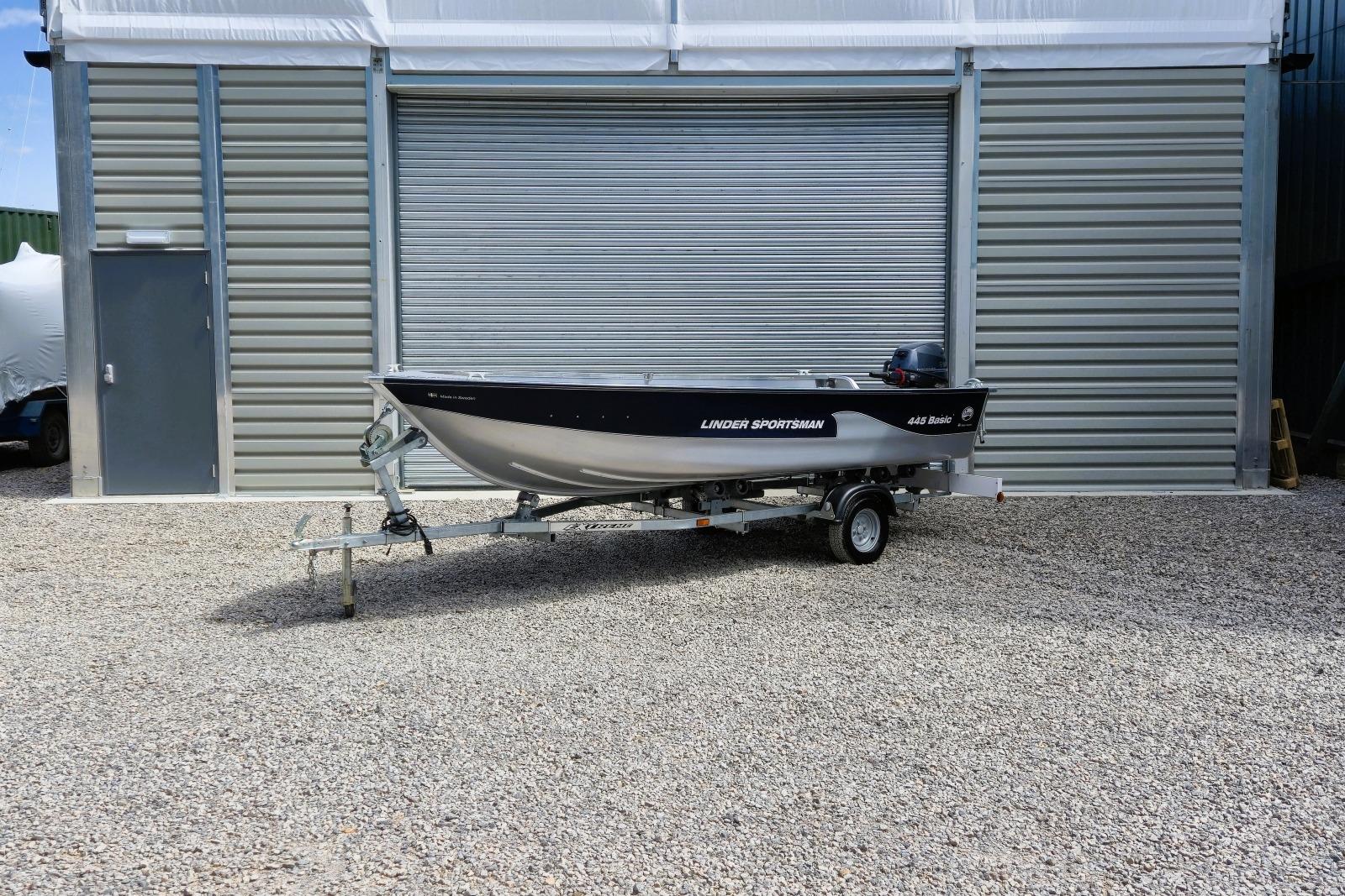 2026 Linder Sportsman 445 Basic Package boat on trailer, parked outside a metal building.