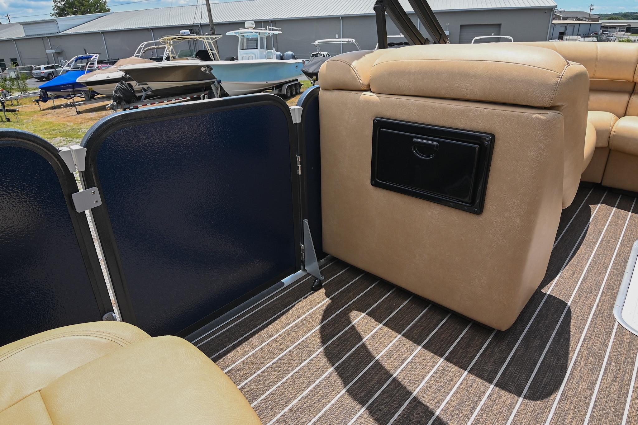 Interior of 2023 Premier 270 Intrigue RF boat with tan seating and striped flooring.