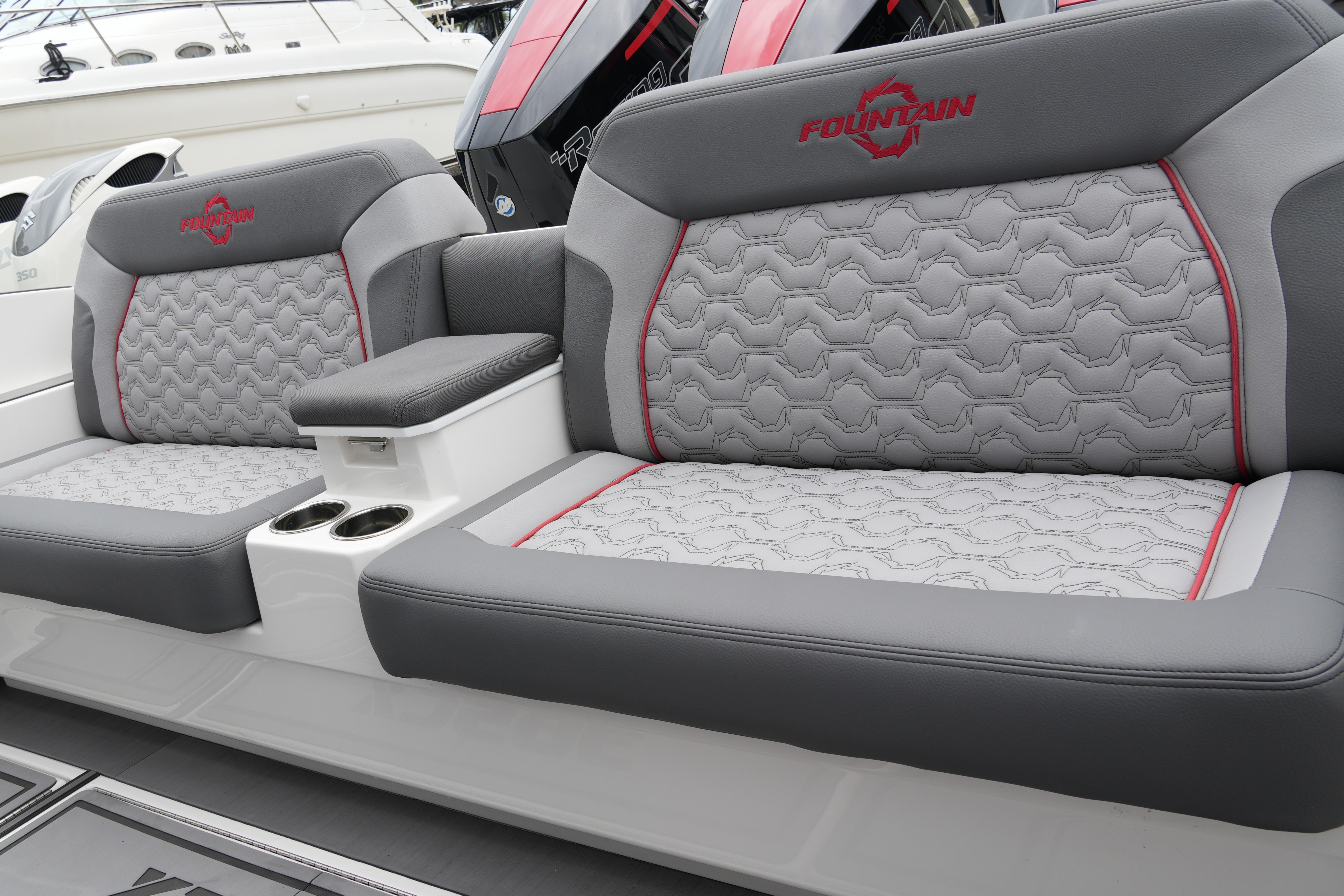 2025 Fountain 38 SCX boat seats with gray and red accents, featuring cup holders.