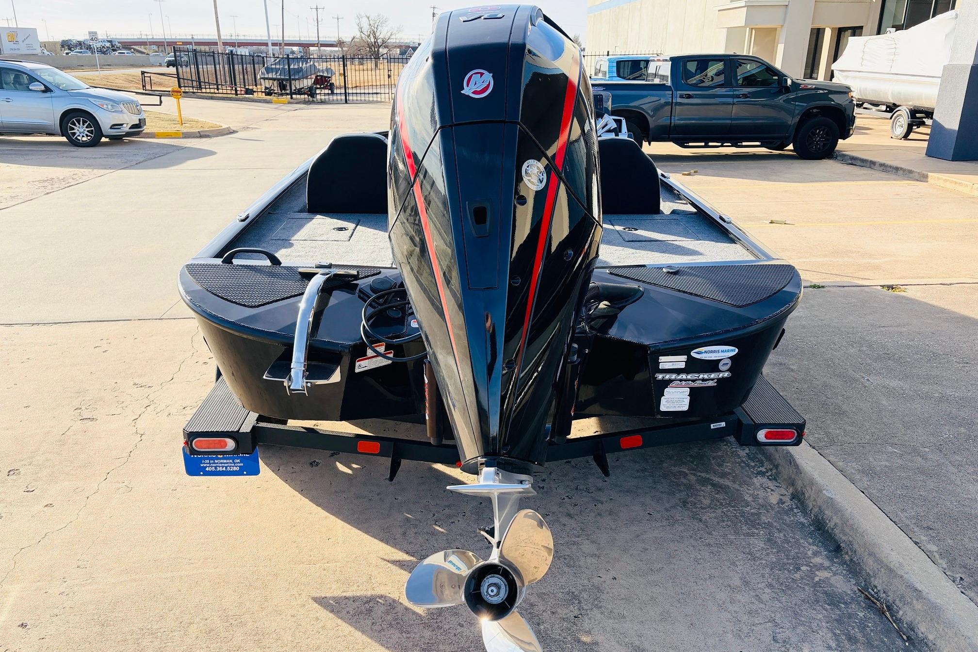 2025 Tracker Savage 215 boat with powerful outboard motor, parked on concrete surface.