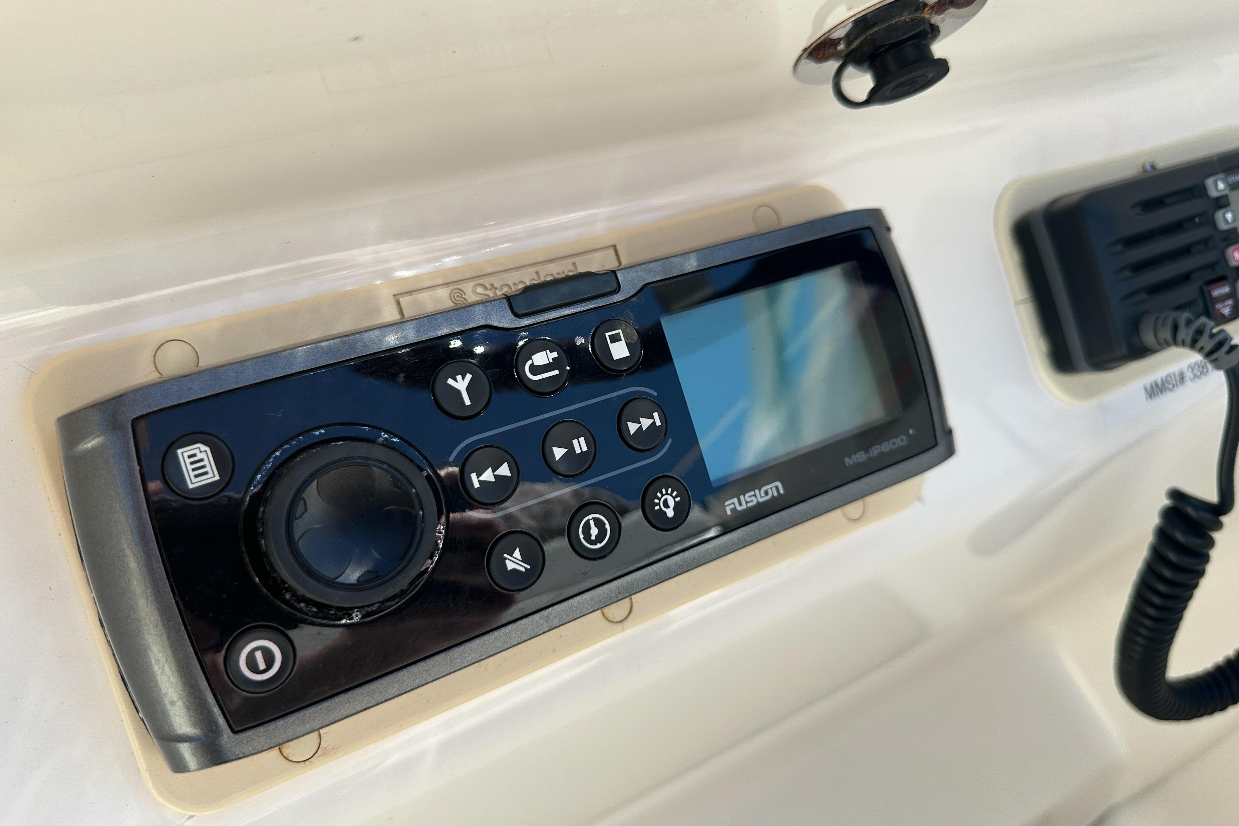 Fusion marine stereo system on a 1998 Sea Ray 215 Express Cruiser dashboard.