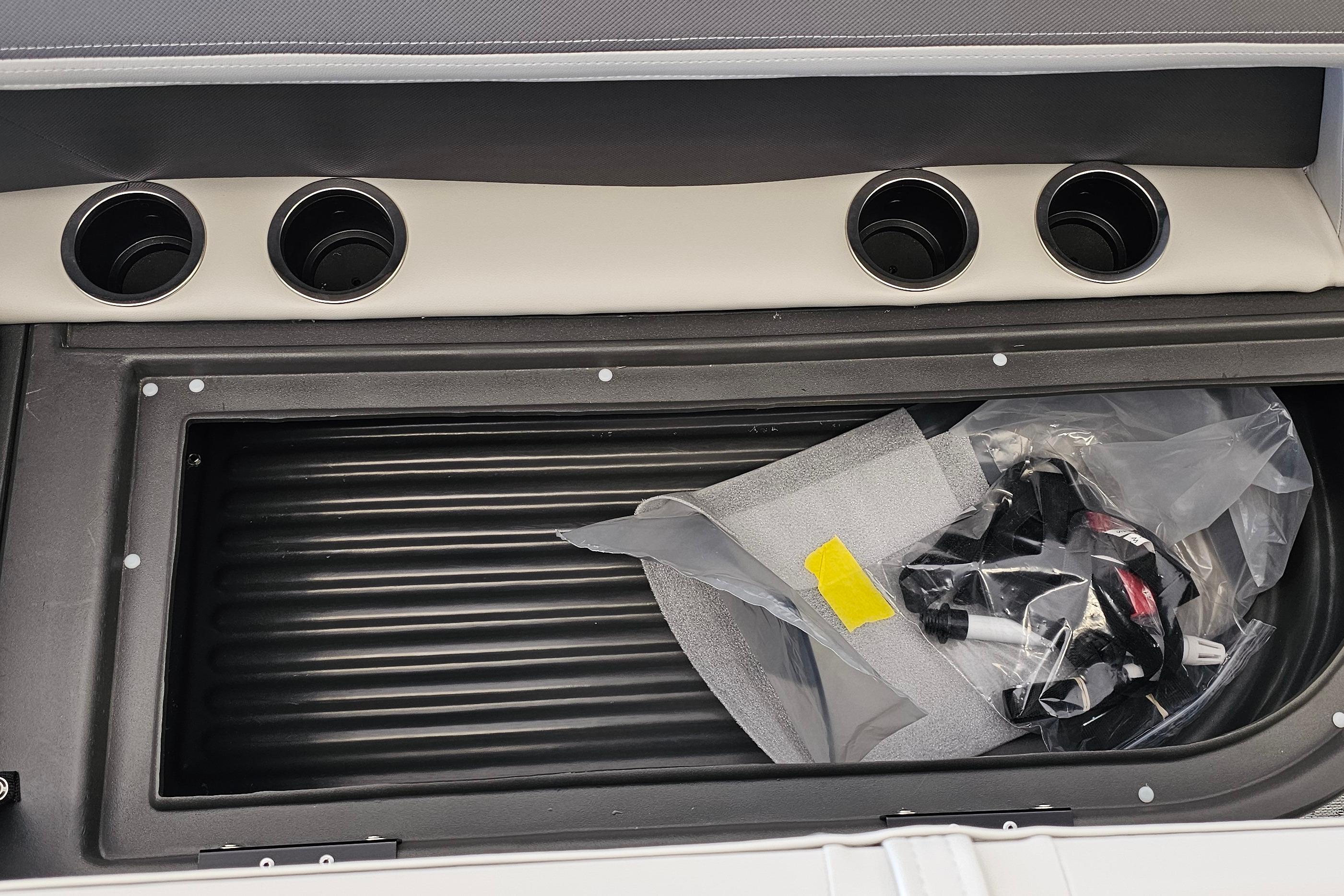 2026 Sun Tracker Bass Buggy 16 XL Select storage compartment with cup holders and accessories.