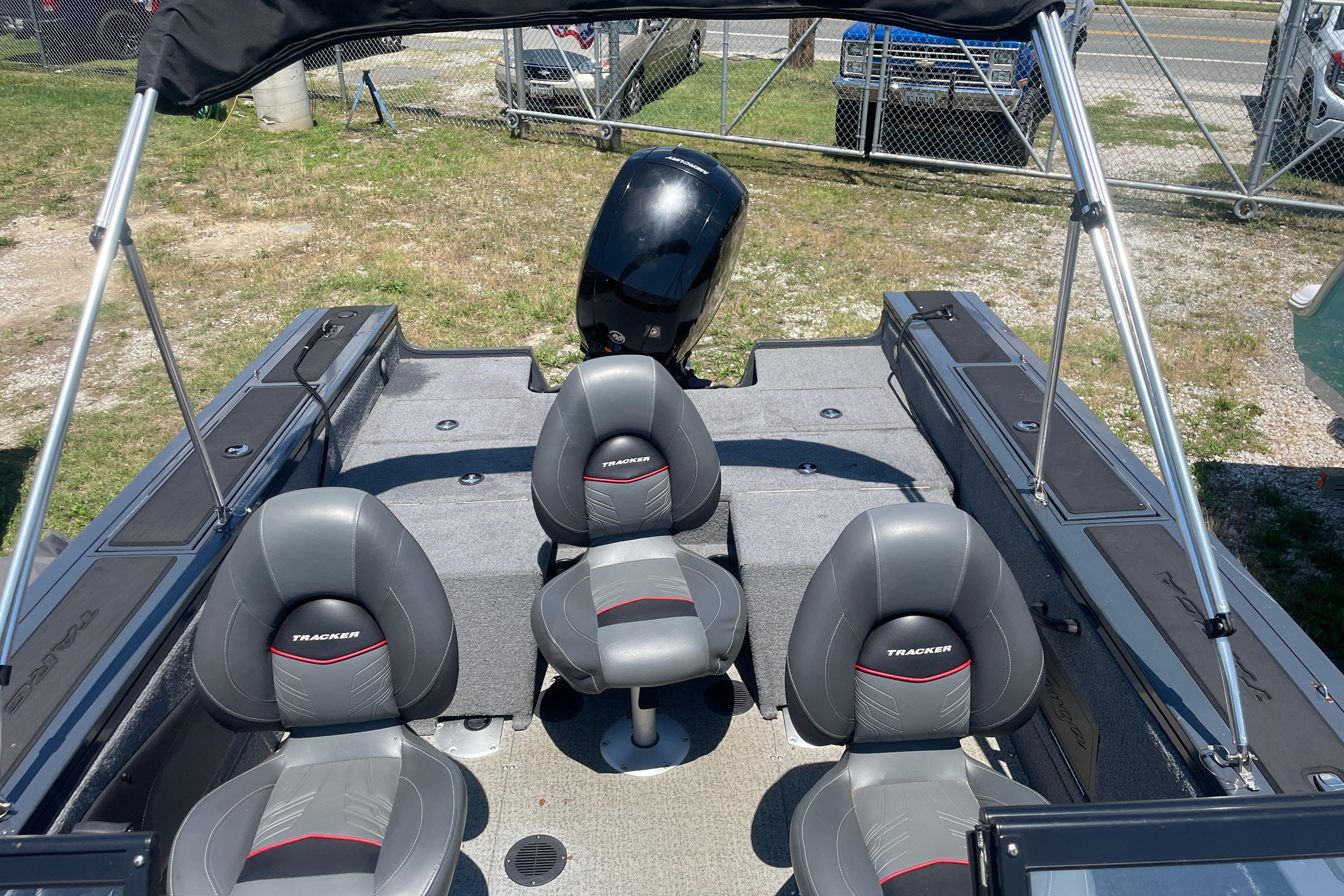 2022 Tracker Targa V-18 WT boat interior with seating and motor, parked outdoors.