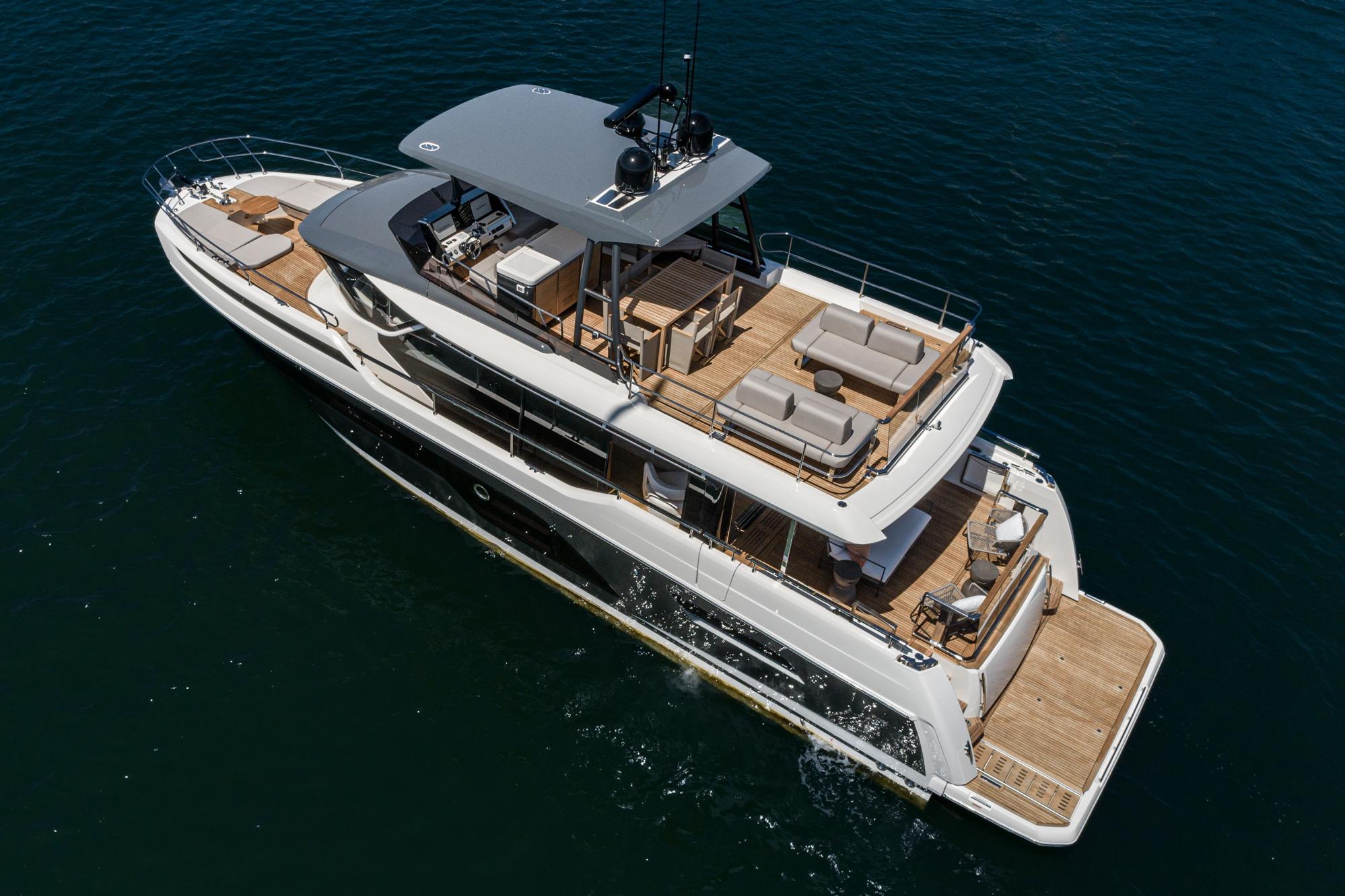 2024 Prestige X60 luxury yacht cruising on open water, showcasing elegant design and spacious decks.