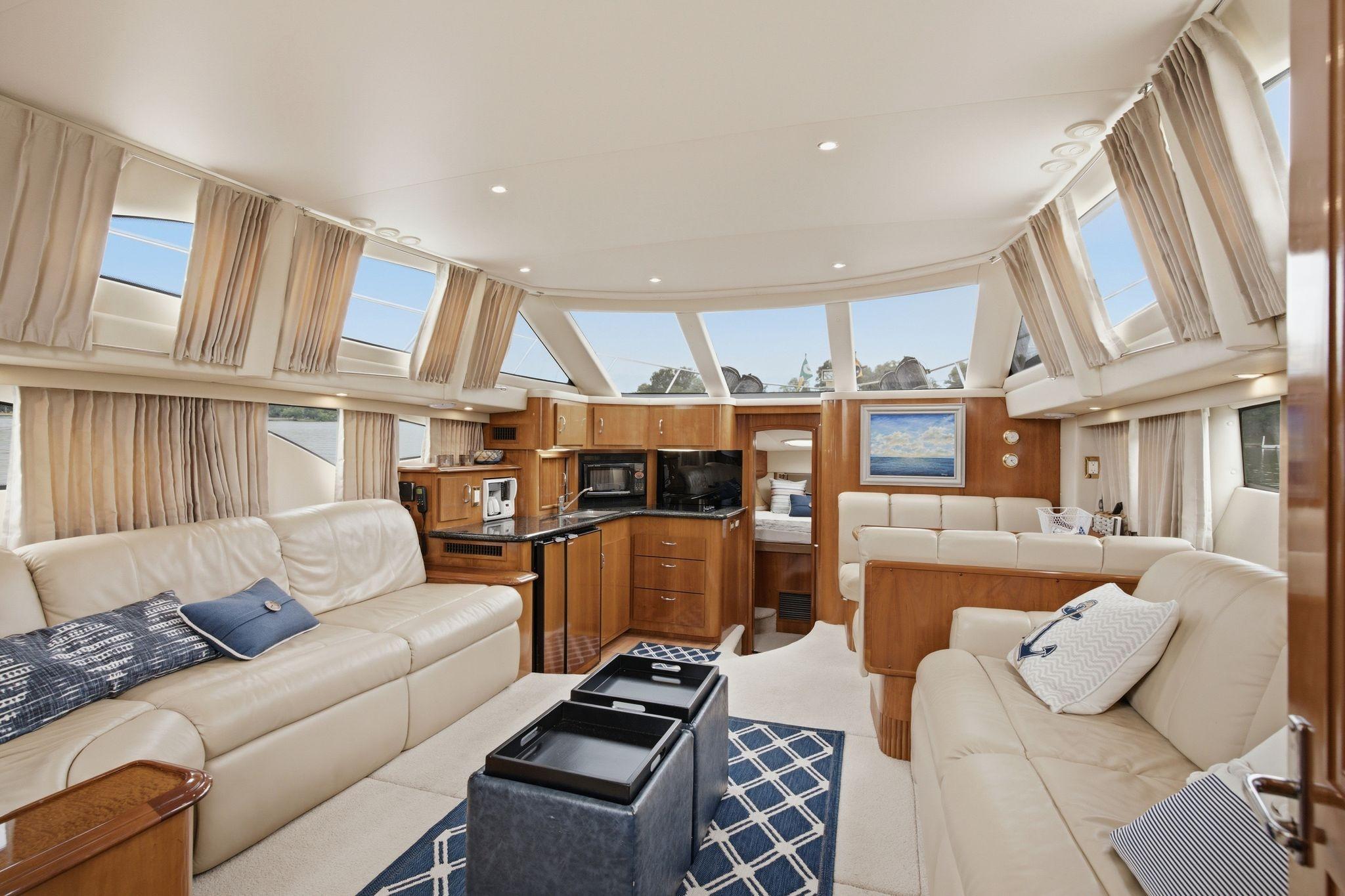 Luxurious interior of 2005 Carver 39 Motor Yacht with elegant furnishings and panoramic windows.