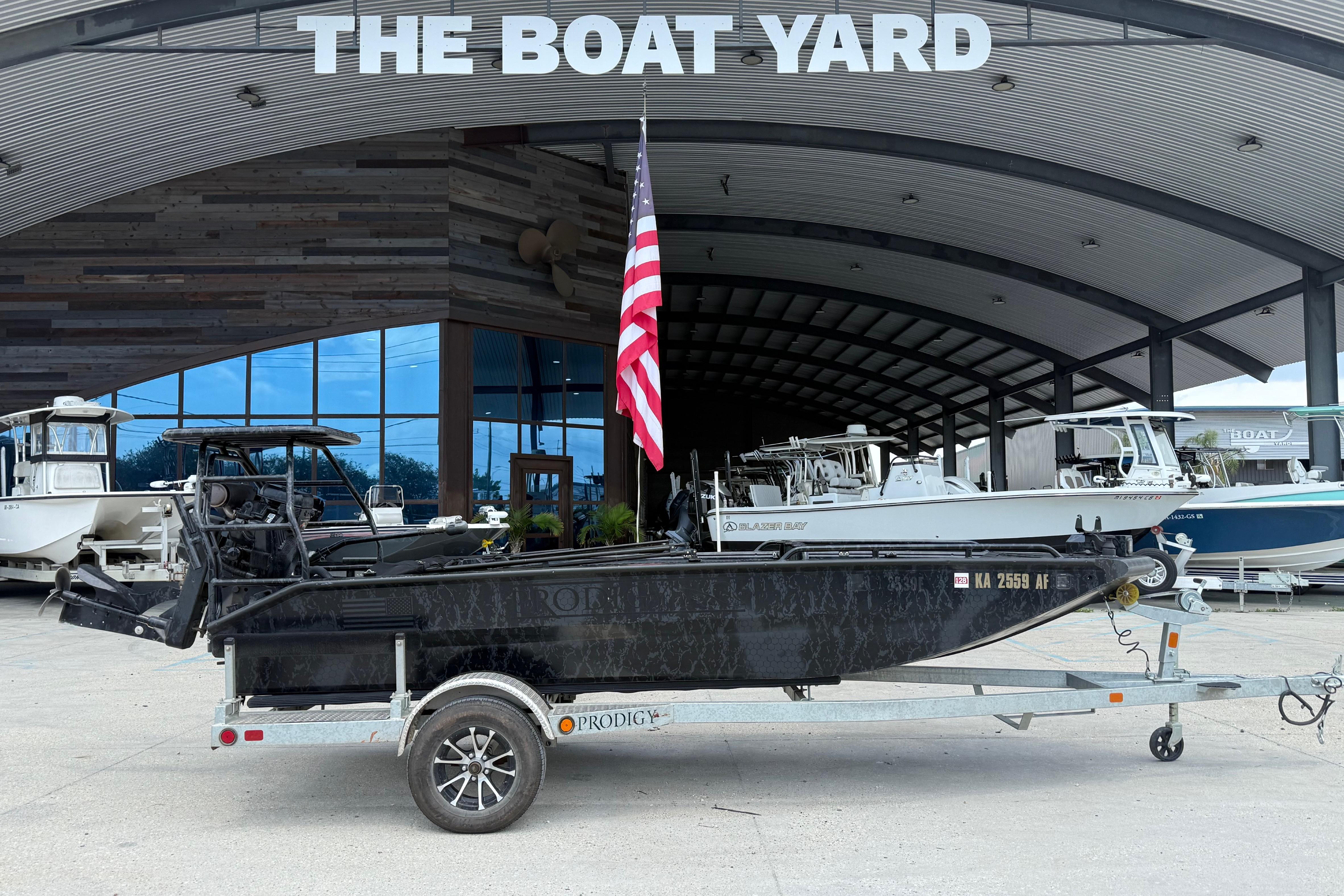 2024 Prodigy 17 boat on trailer at The Boat Yard, American flag displayed.
