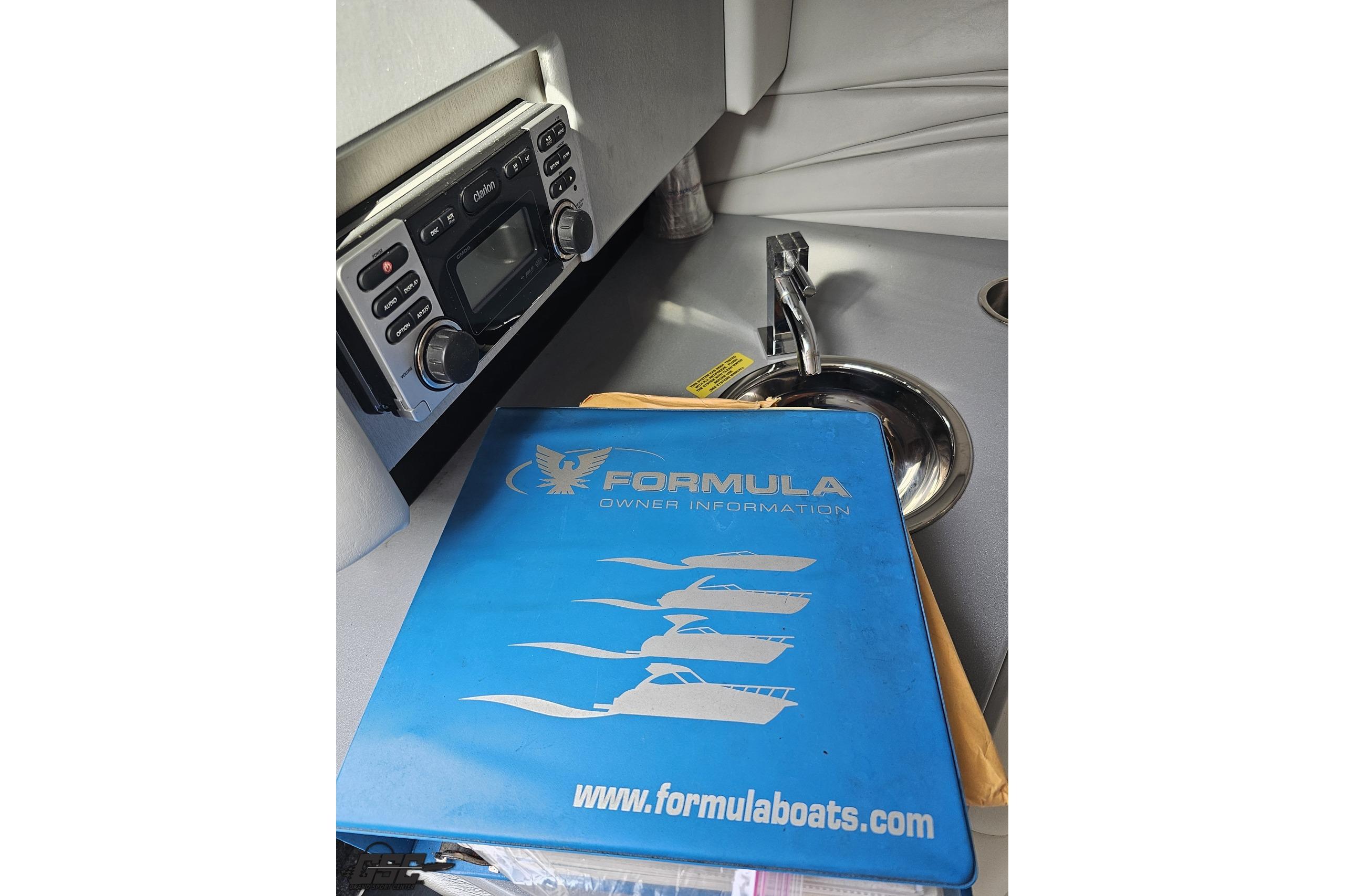 2014 Formula 292 FASTech boat manual and stereo system in cabin interior.