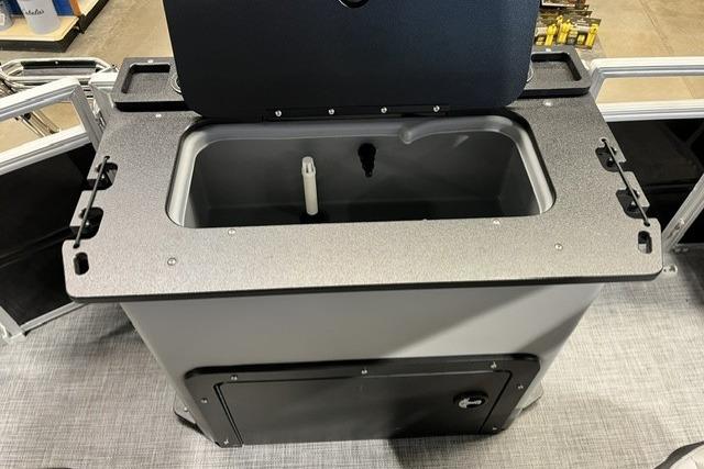 2026 Sun Tracker SportFish 20 DLX livewell, open lid, gray interior, on a pontoon boat.