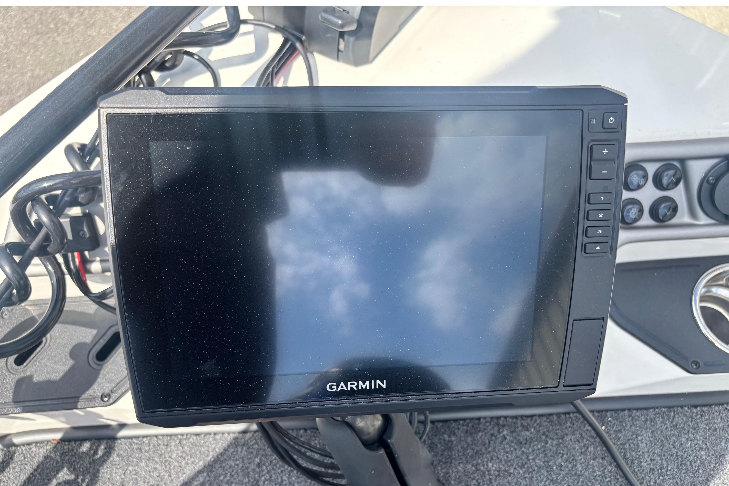 Garmin display on 2022 Ranger 1880MS boat dashboard, showing control buttons and reflections.