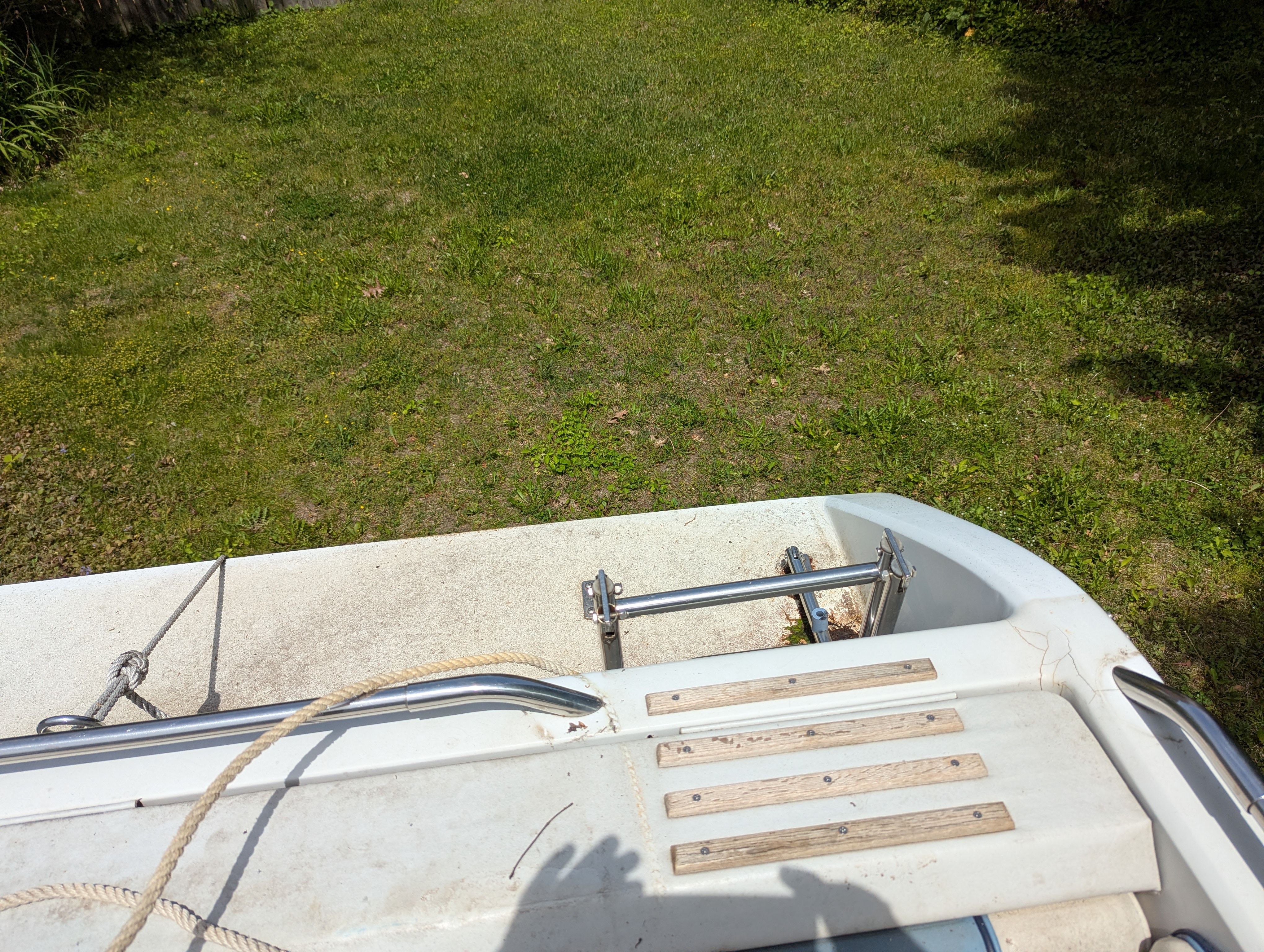 Rear view of a 1988 Four Winns 200 Horizon boat on grass.