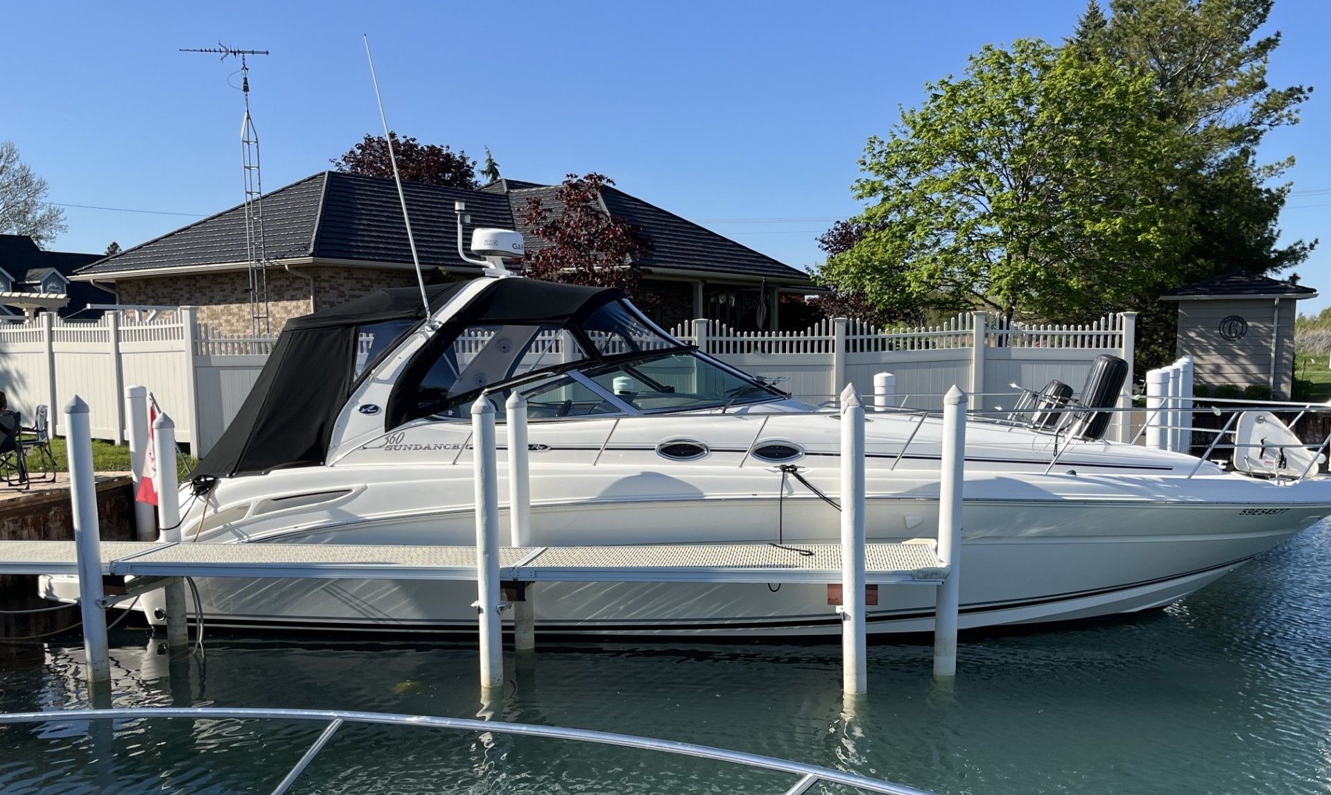 2005 Sea Ray Sundancer boat docked, sunny day.
