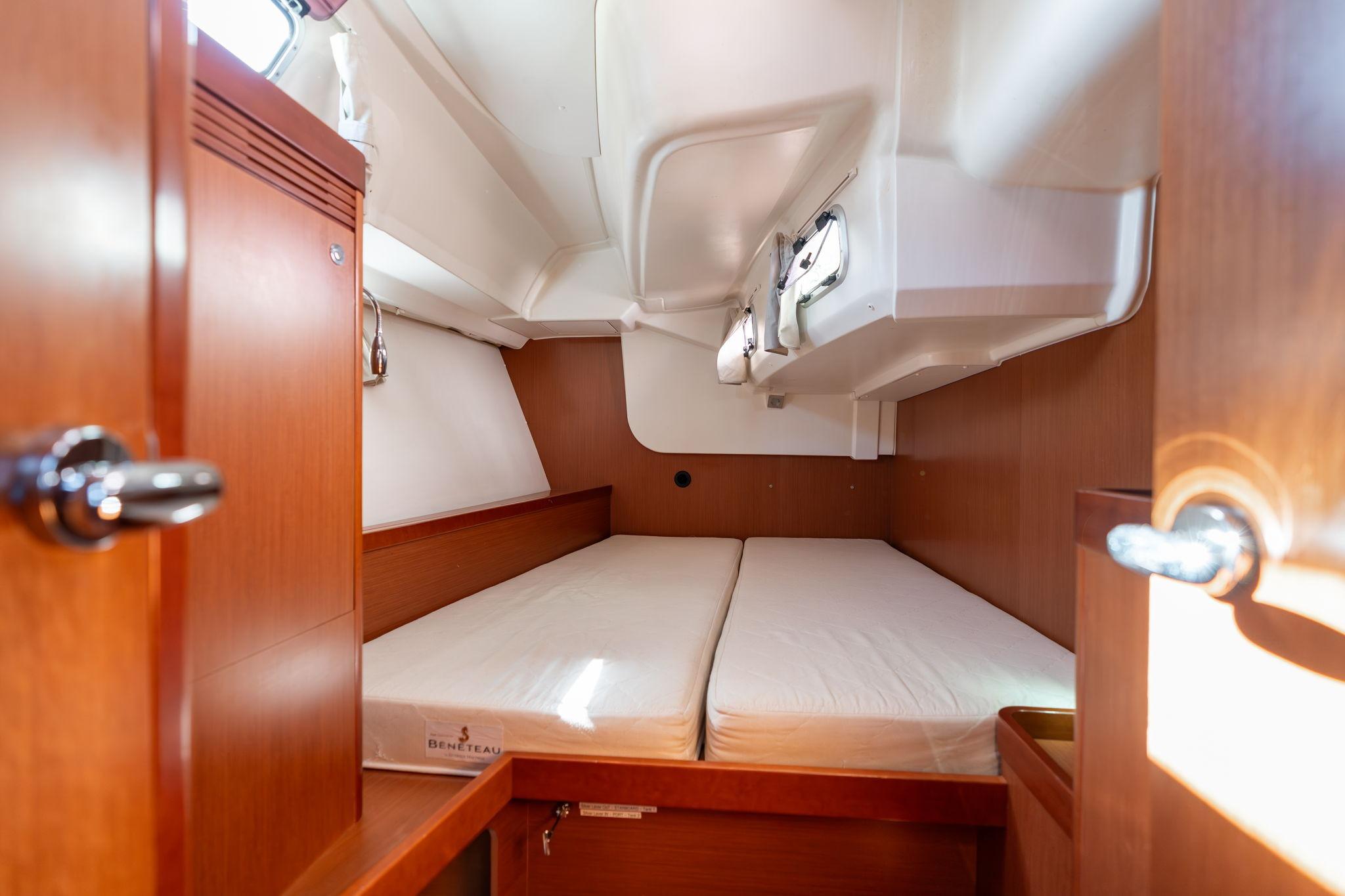 2013 Beneteau Oceanis 50 cabin interior with wooden finish and twin beds.