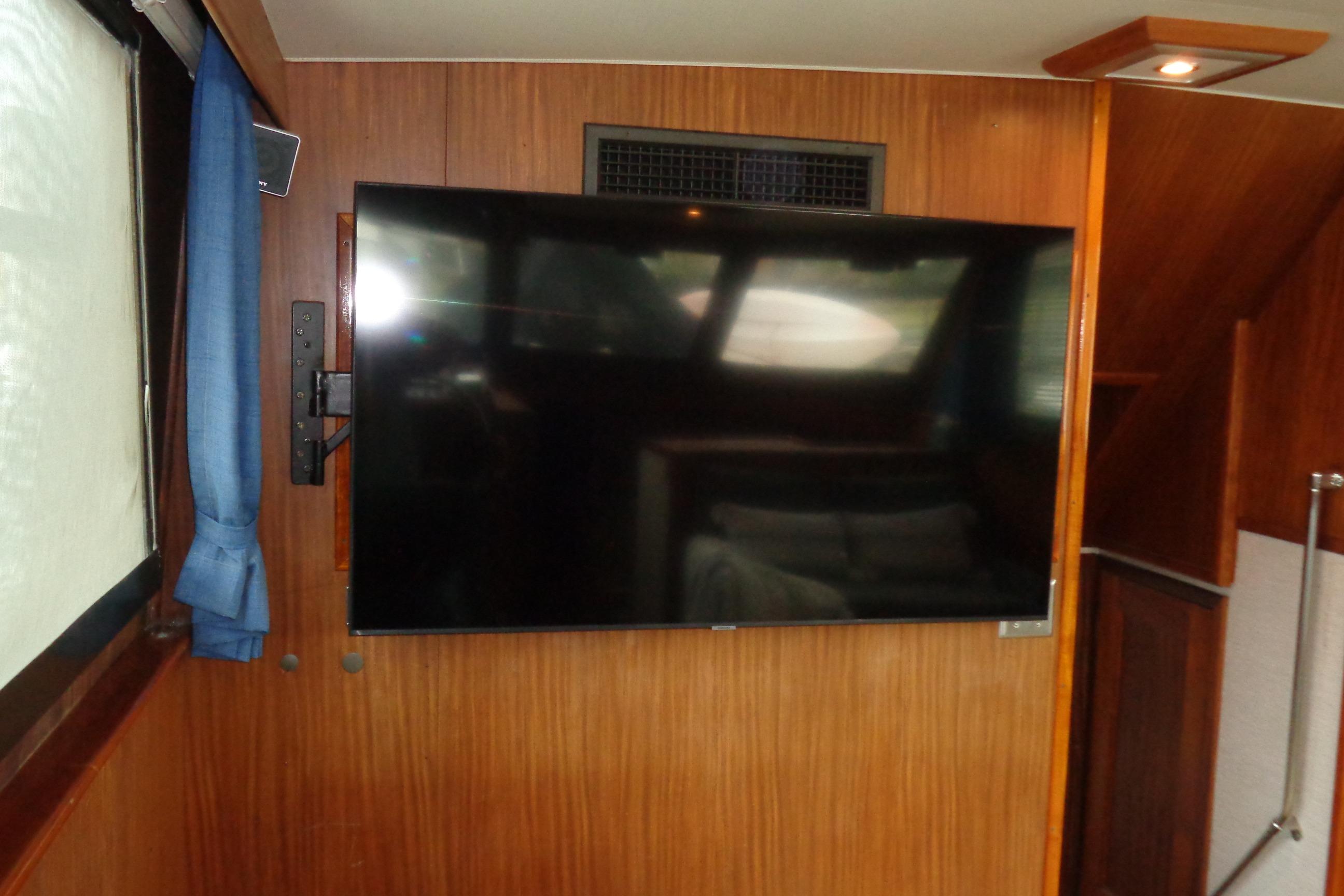 Interior of 1981 Hatteras 48 Cockpit Motor Yacht with mounted flat-screen TV.