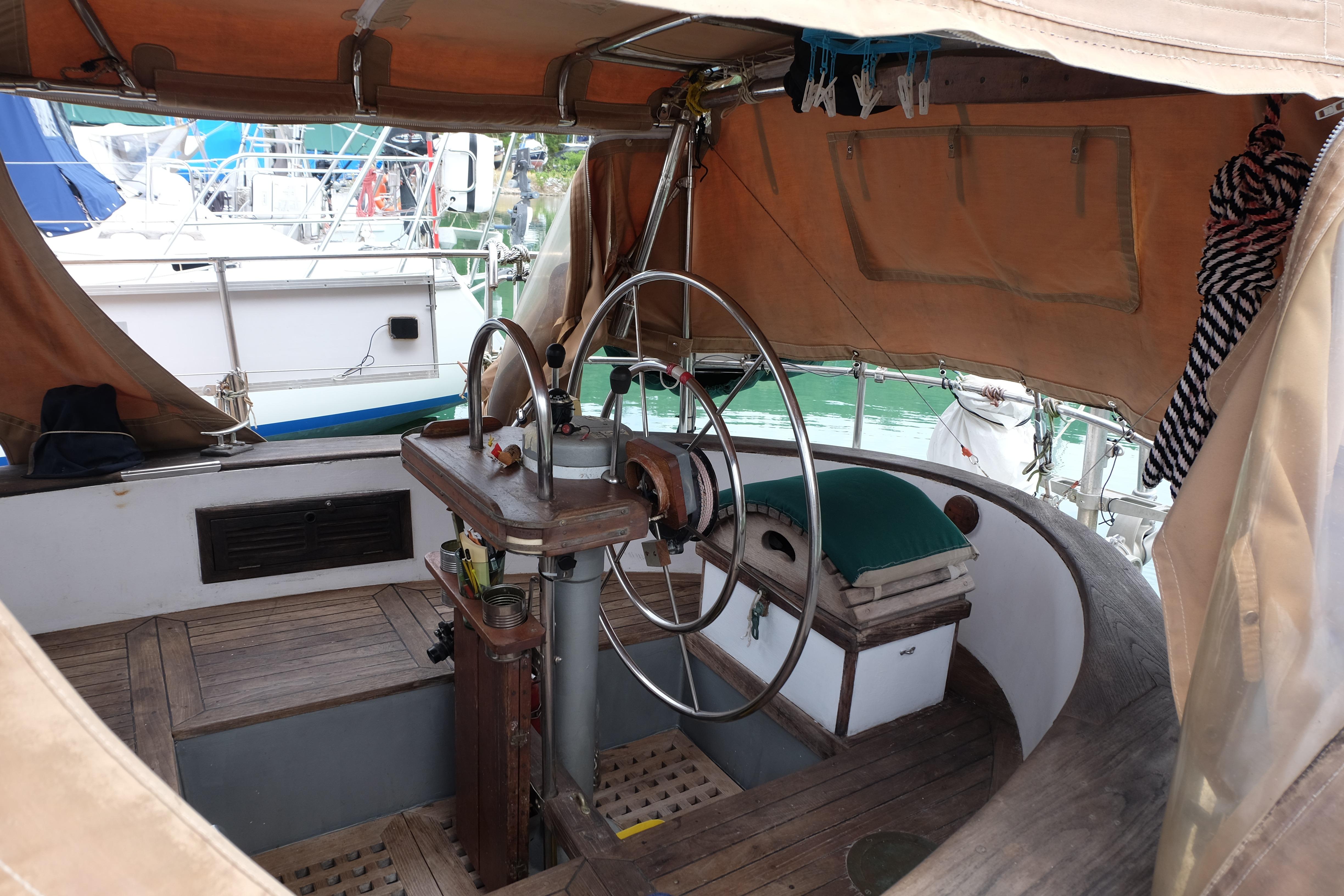 1979 Westwind 35 sailboat cockpit with wooden deck and steering wheel.