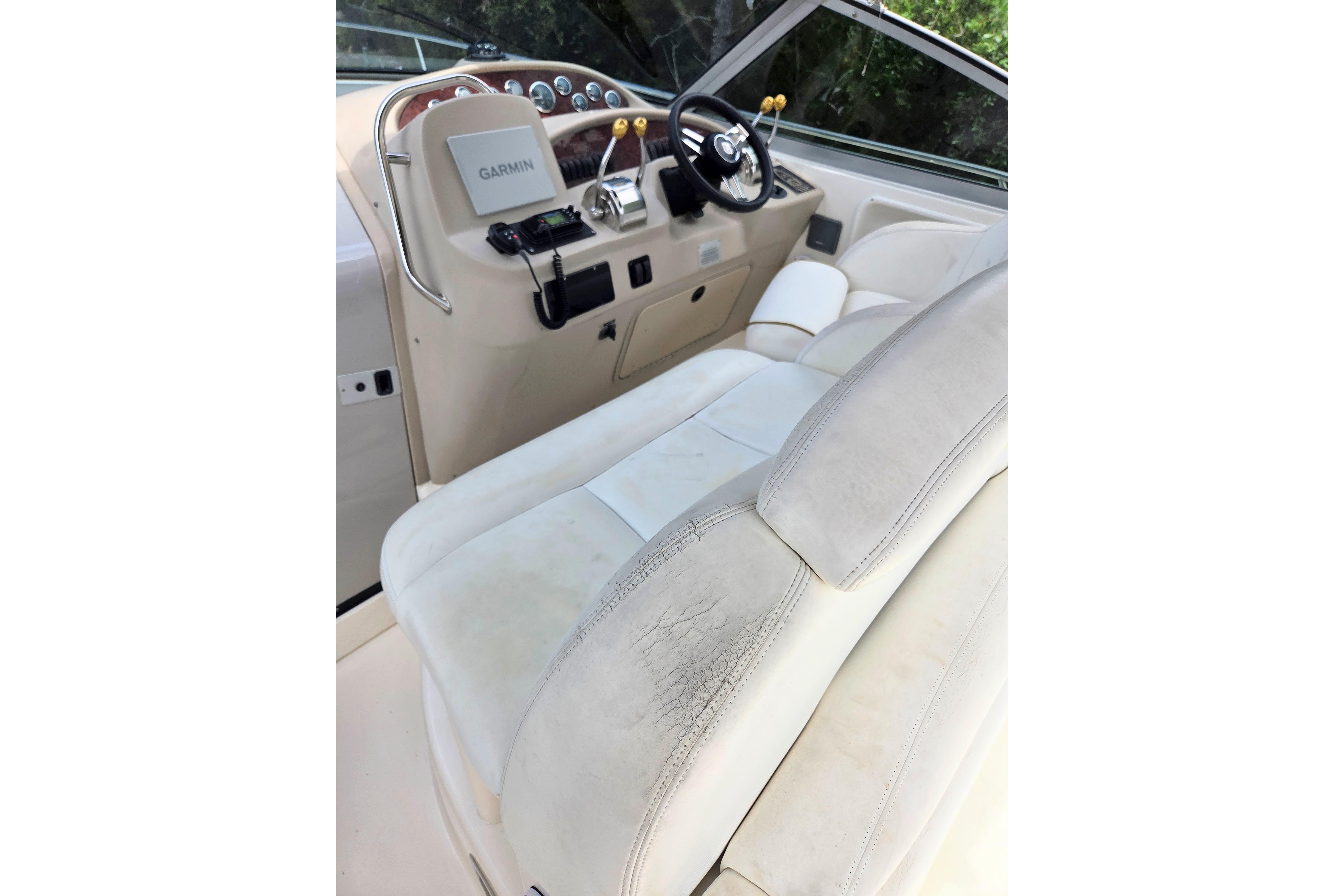 Cockpit of 2000 Sea Ray 340 Sundancer with Garmin navigation system and leather seating.